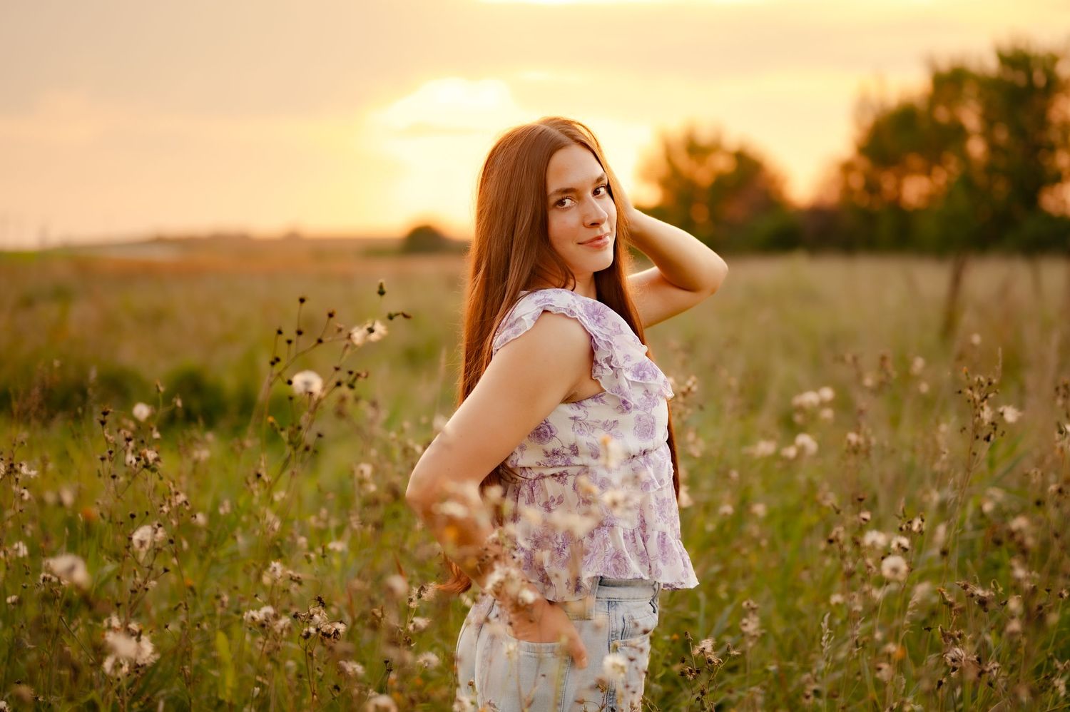 Golden hour portraits in a wildflower meadow with warm sunset lighting.