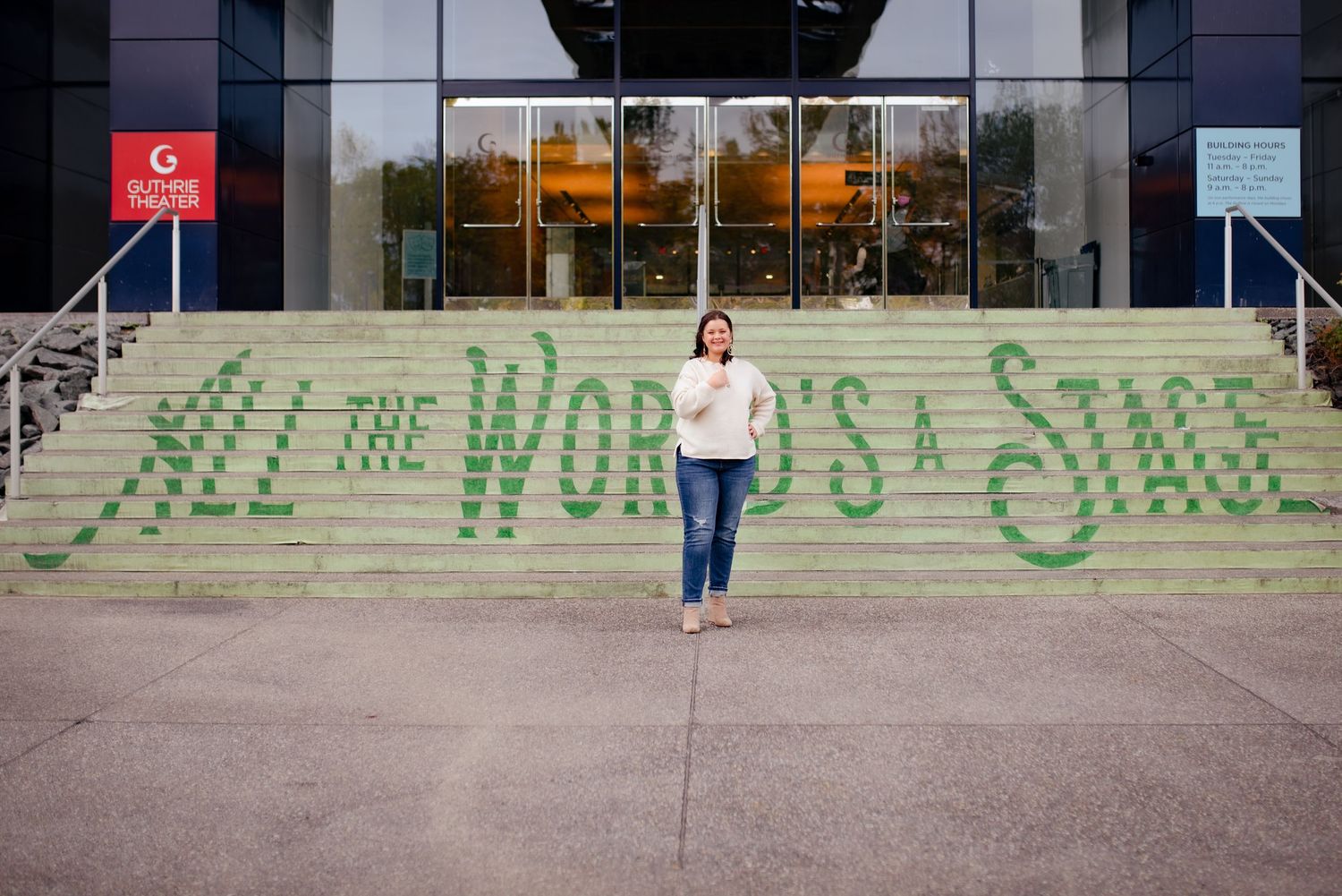 A figure stands on concrete steps with green graffiti text in the background.