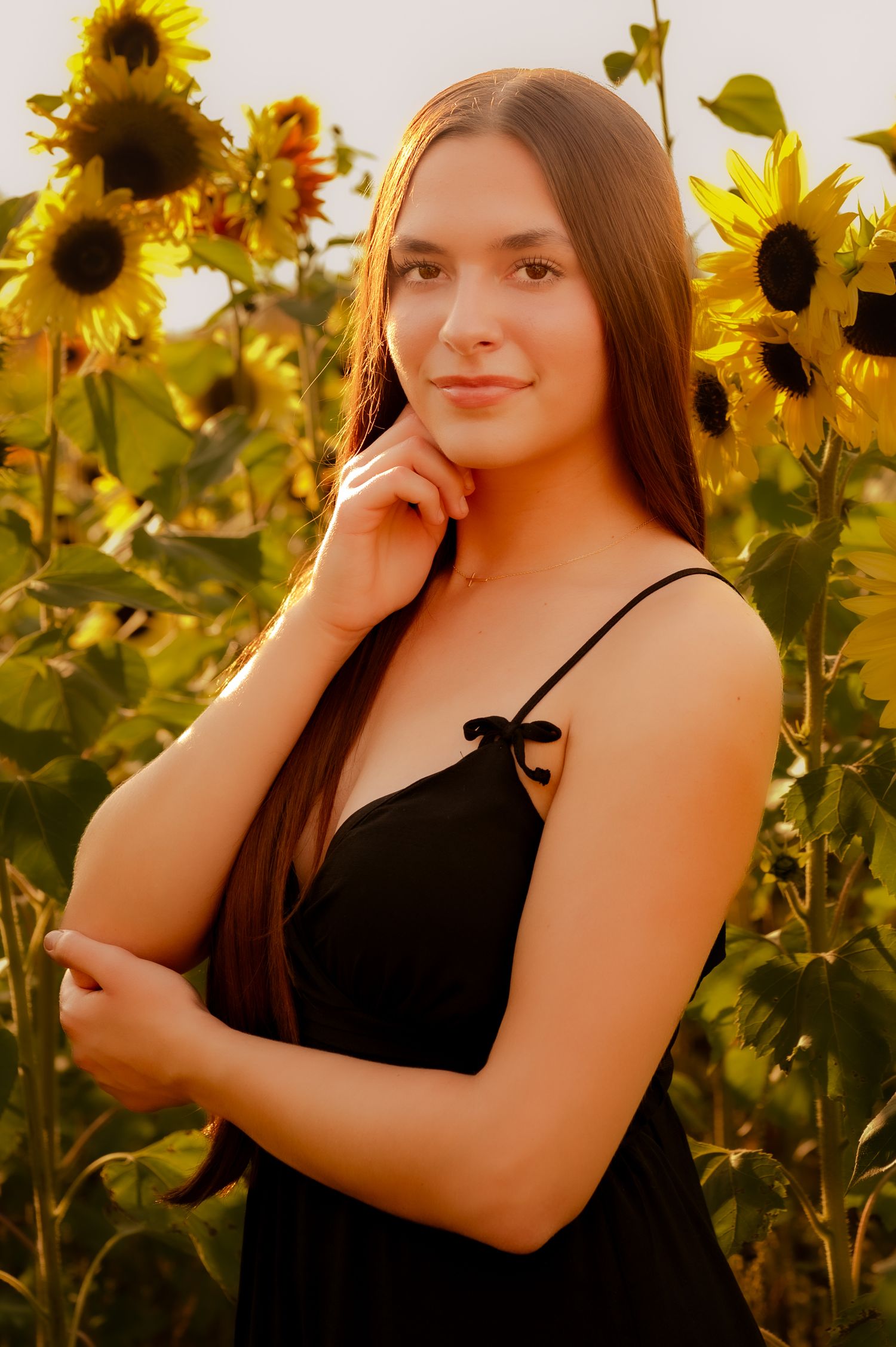 A beautiful sunset photoshoot in a vibrant sunflower field during golden hour.