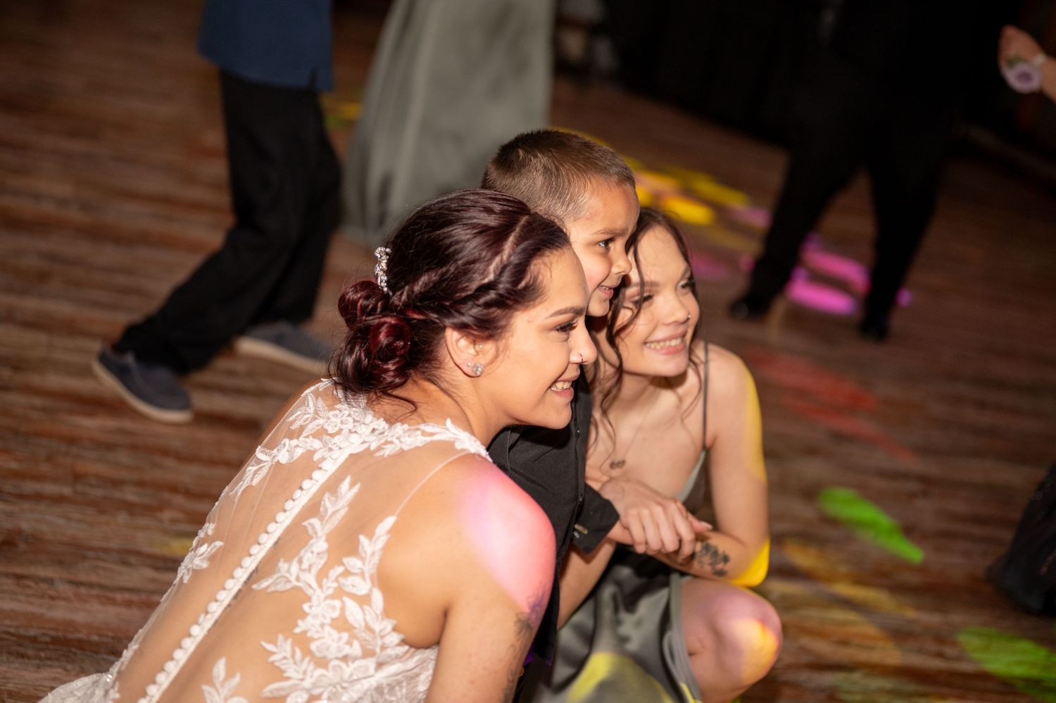 Candid moment of wedding guests enjoying themselves during a dance party.