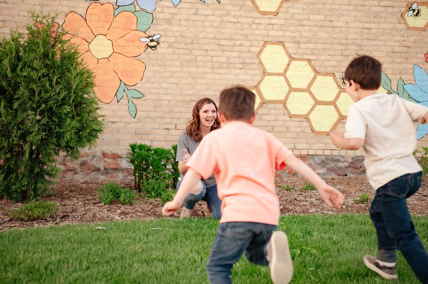 Active playtime scene with running and movement in front of artistic brick wall background.