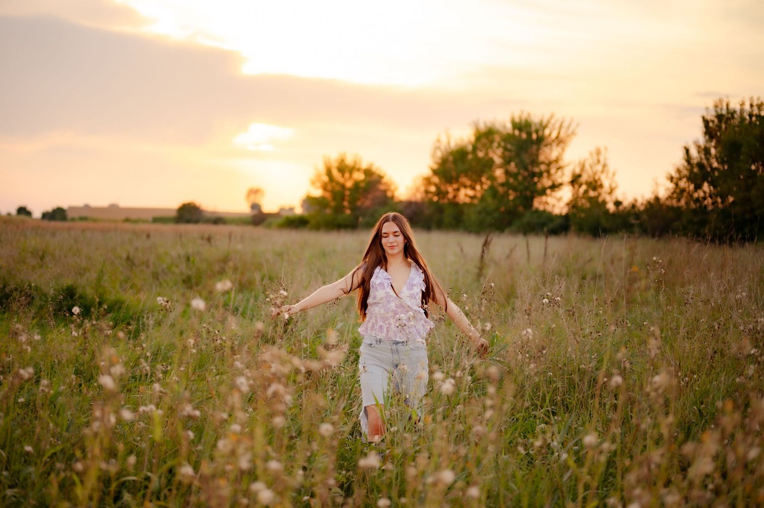 A dreamy summer portrait session in a wildflower meadow at sunset.