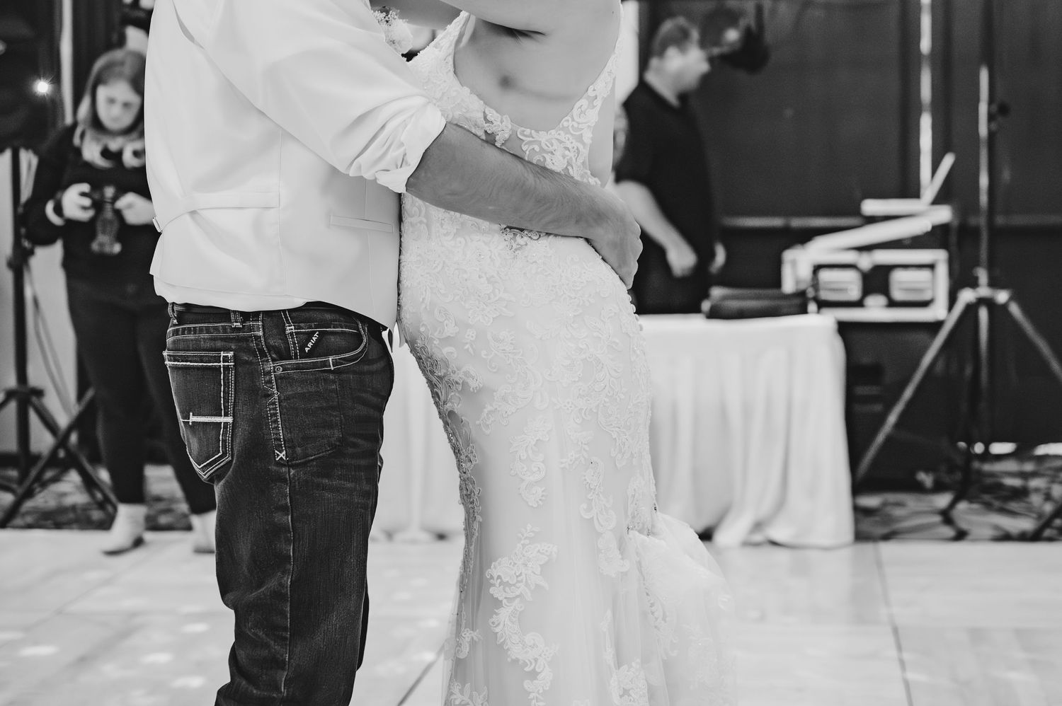 Black and white photo of a couple dancing intimately during their wedding reception.