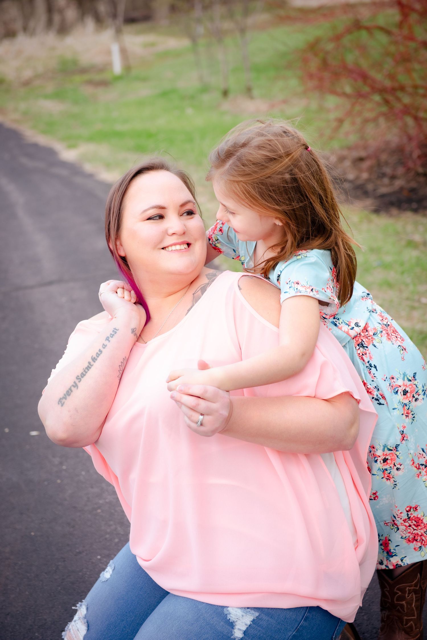 A candid moment of laughter and joy shared on a paved walking trail.