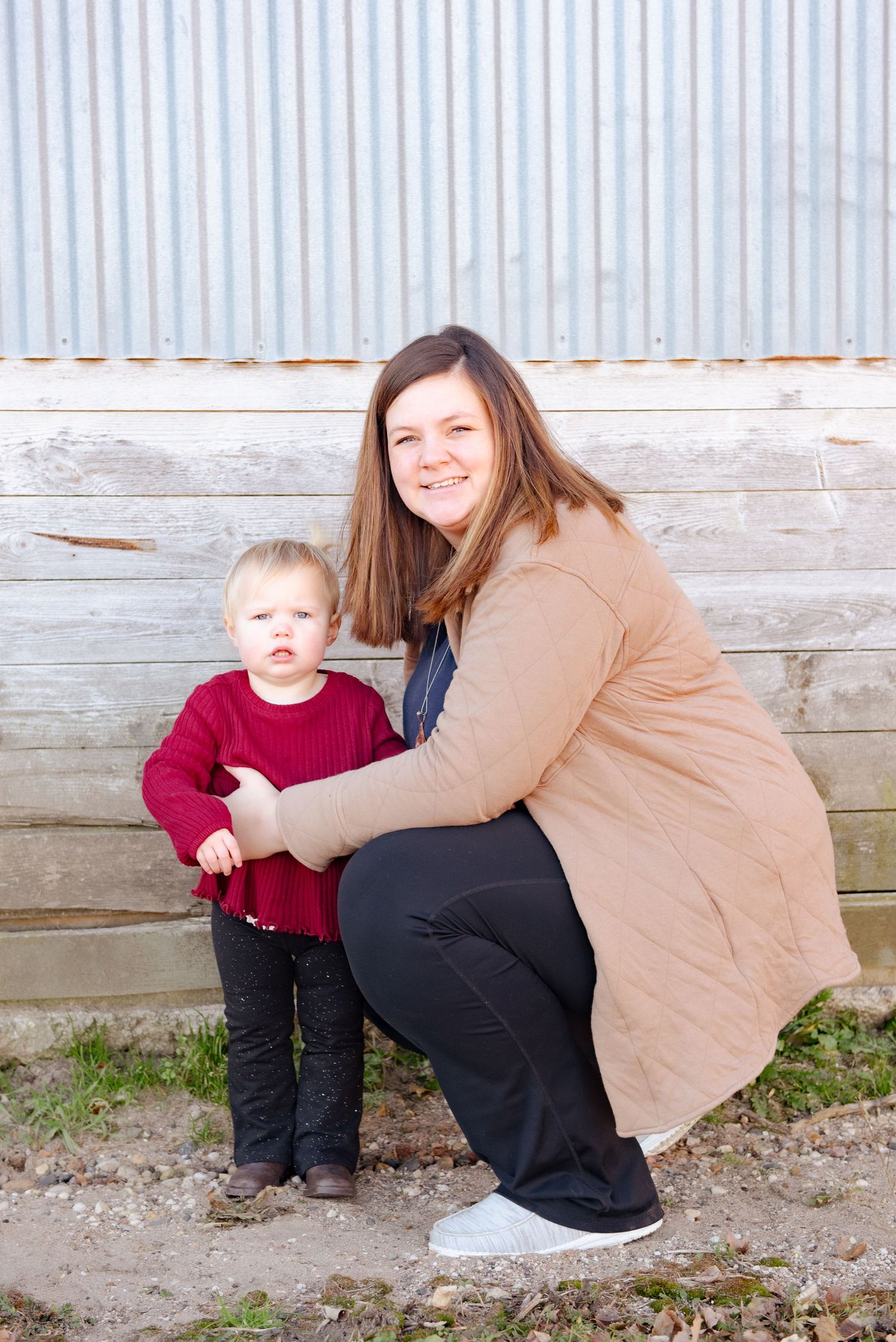 A tender moment between two people against a rustic wooden wall background.