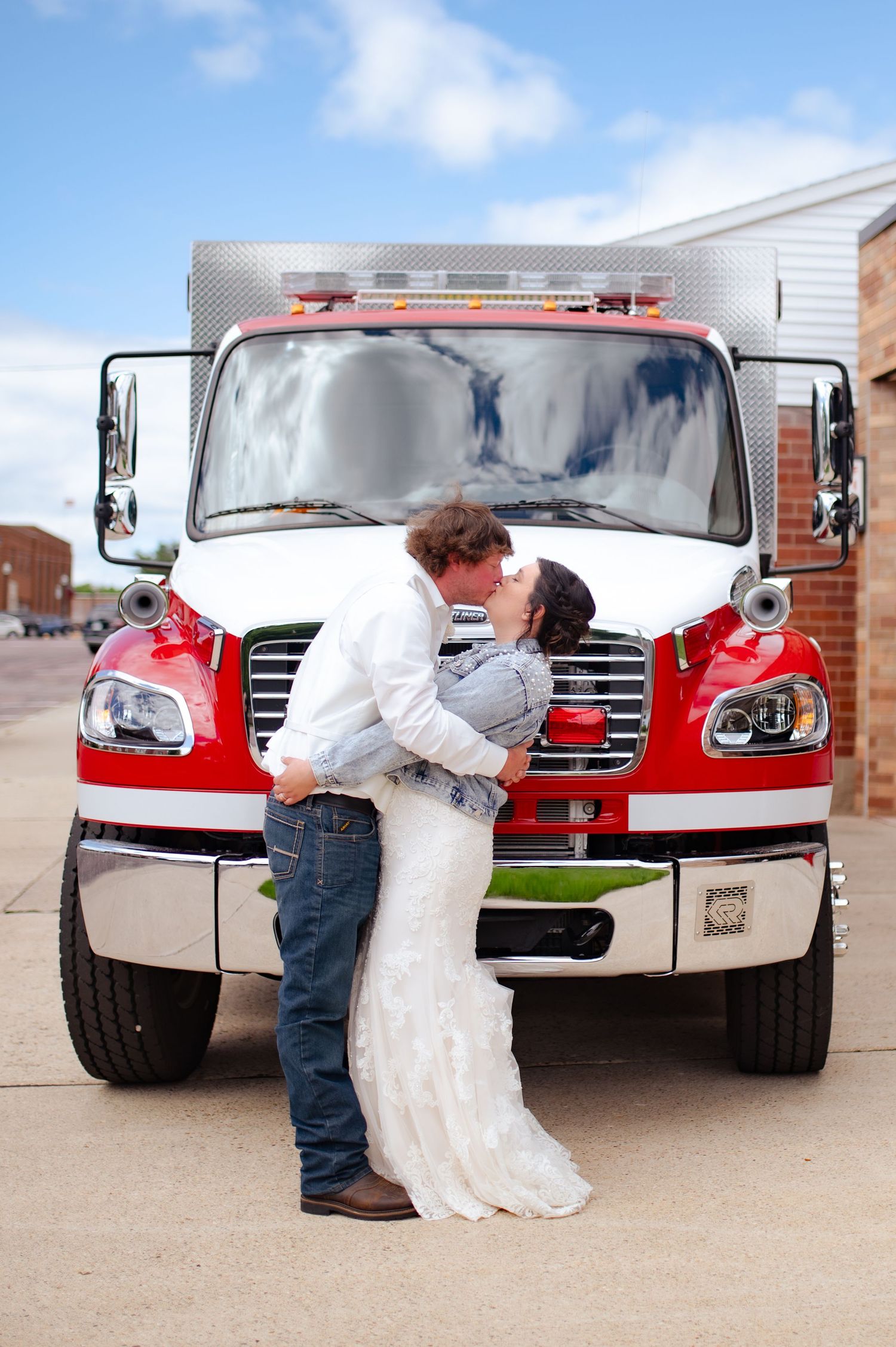 Romantic wedding portrait in front of red fire truck.