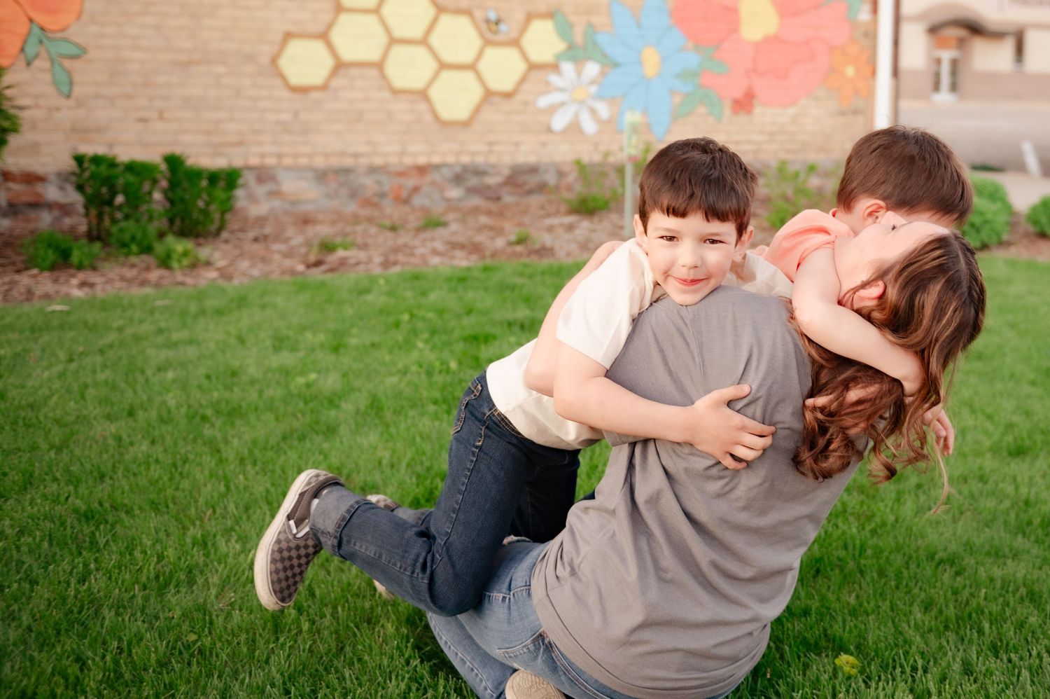 Dynamic action shot showing playful interaction outdoors with decorative wall background.