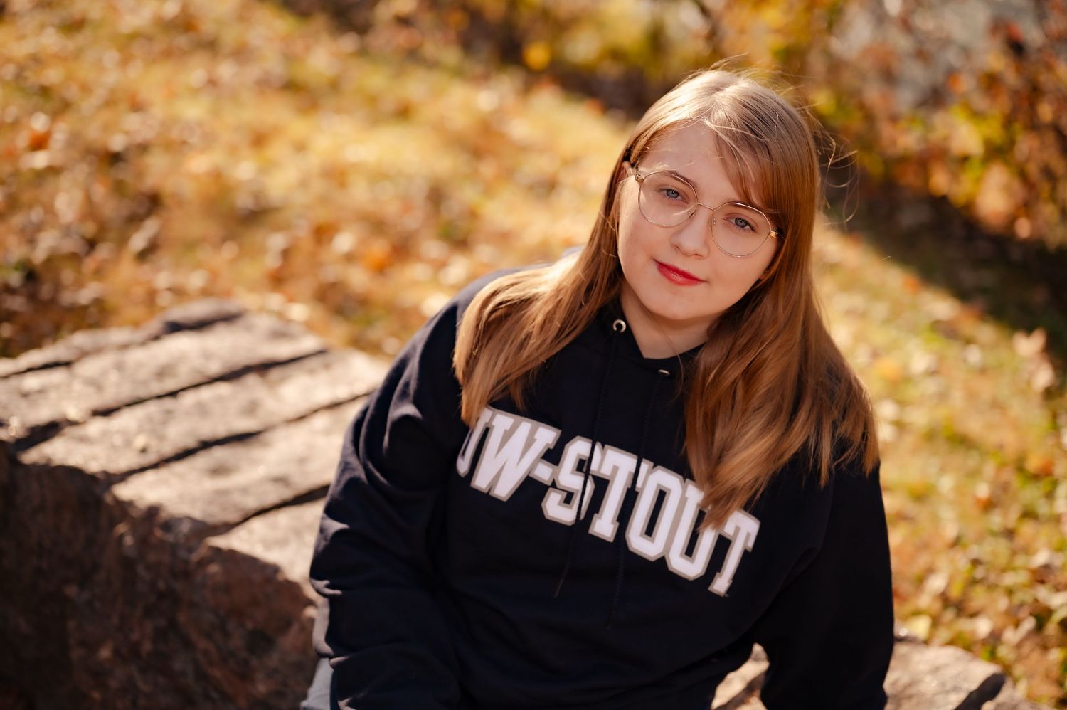 A series of autumn portraits showing someone in a black sweatshirt among golden fallen leaves in an outdoor setting.