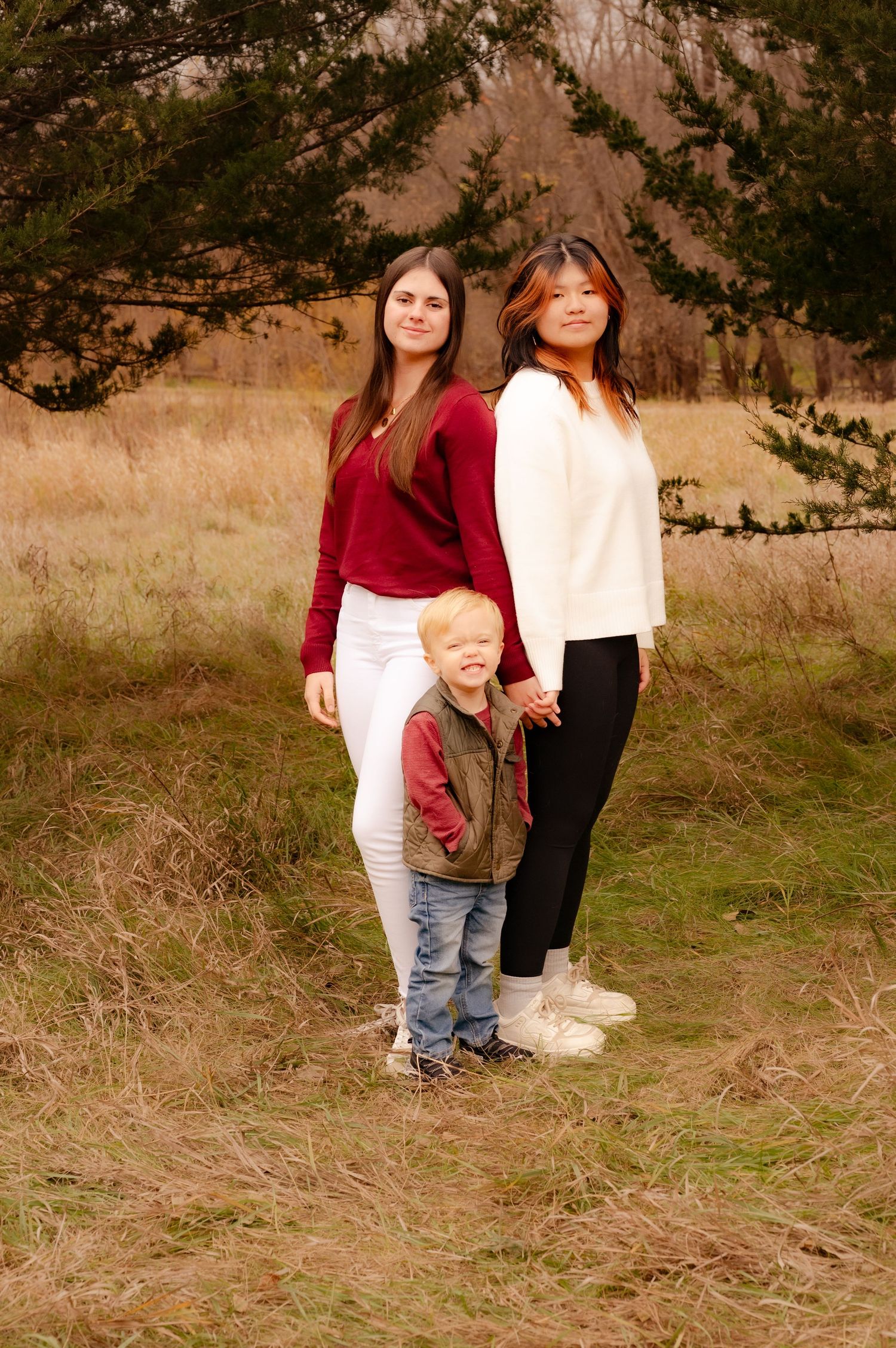 Candid outdoor family portraits showing loving interactions against a natural brown and green backdrop.