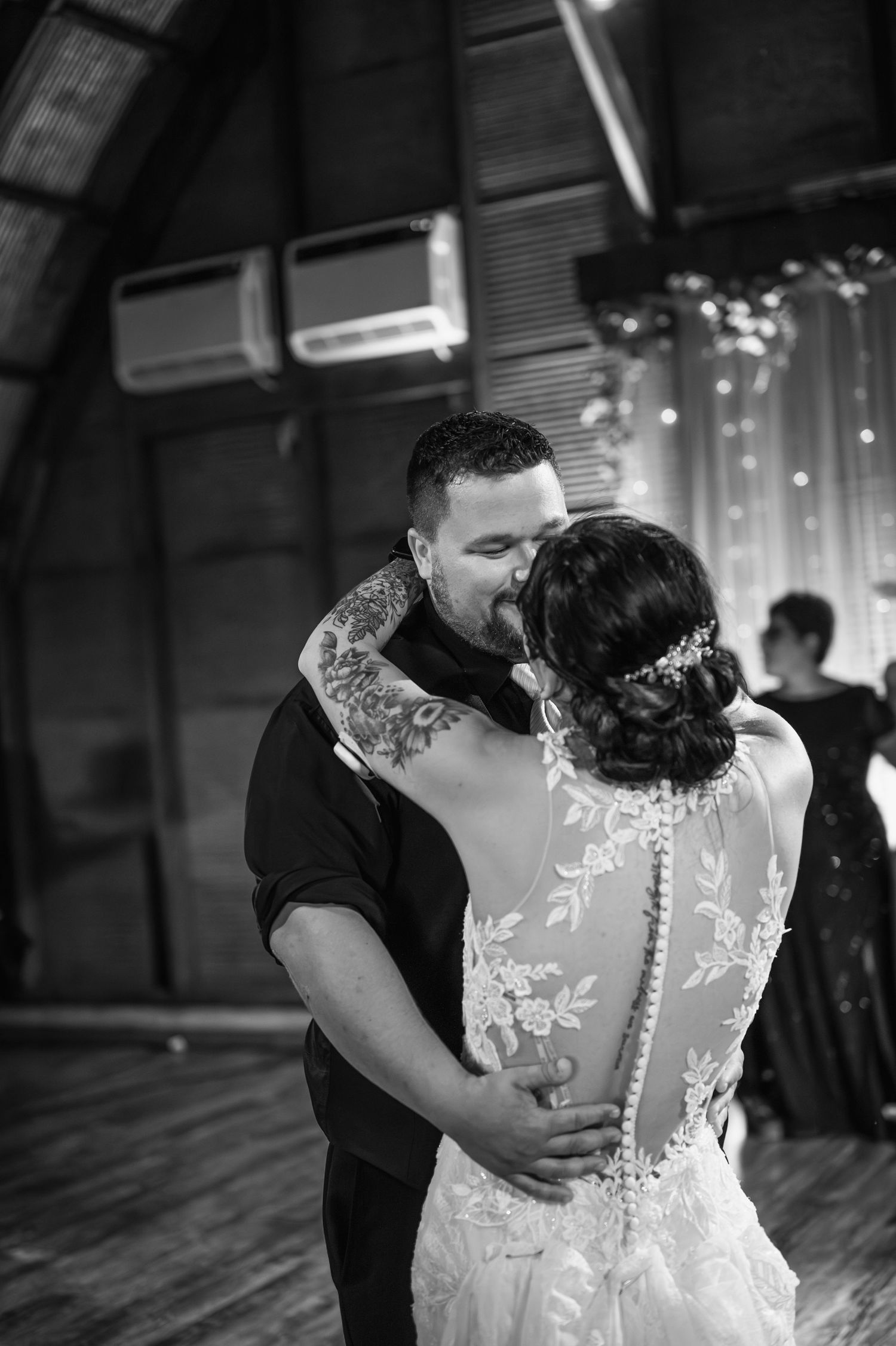 Black and white photo of a couple sharing an intimate dance moment at their wedding reception.