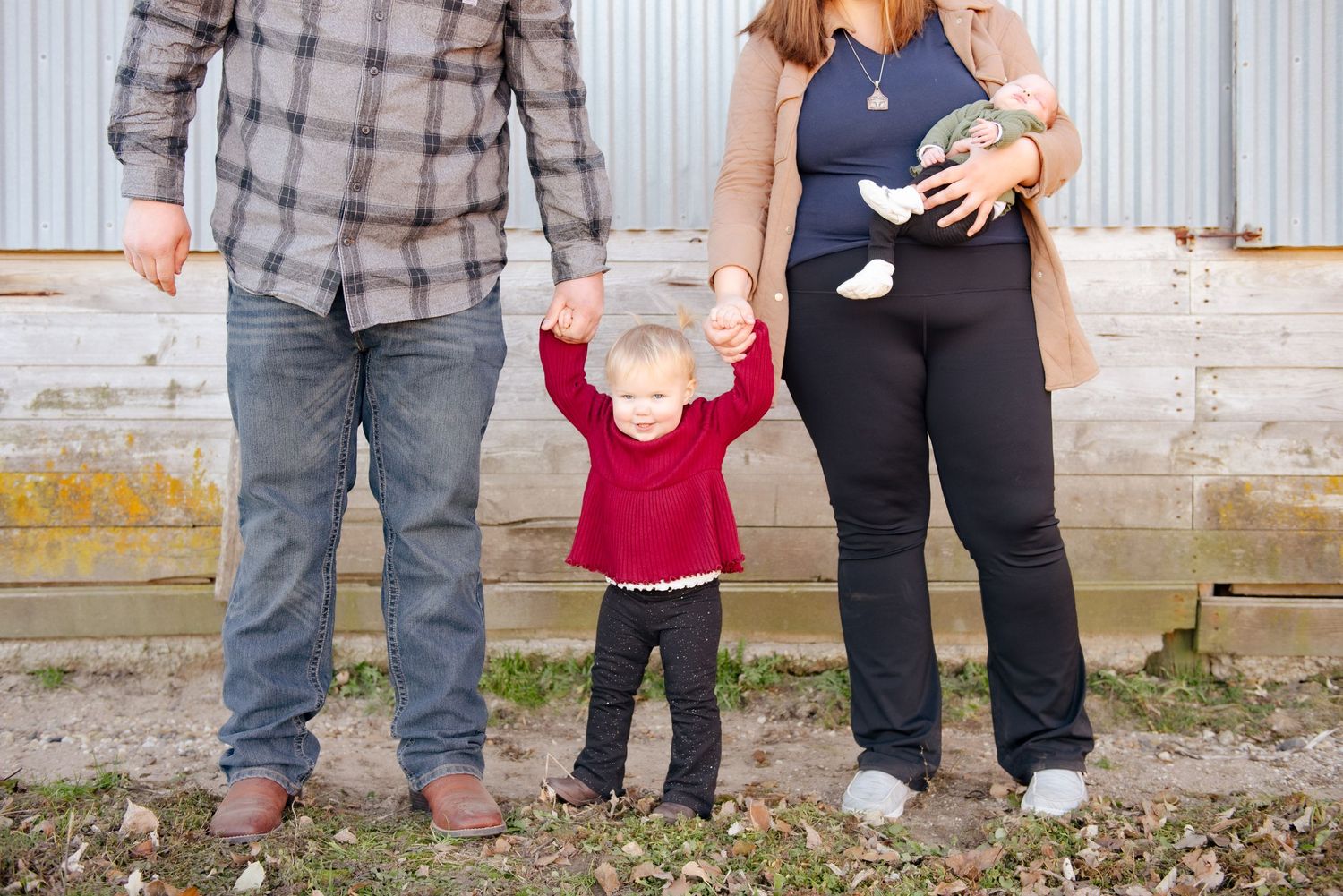 Family photo showing parents and children from waist down.