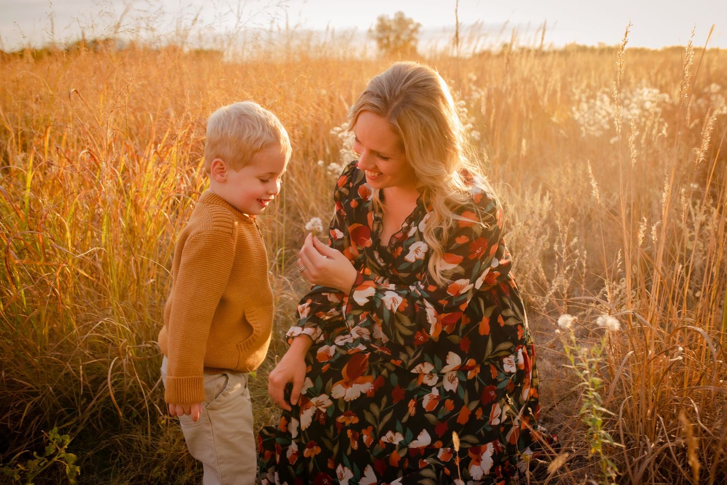 Sweet interaction between two people in autumn field at golden hour.
