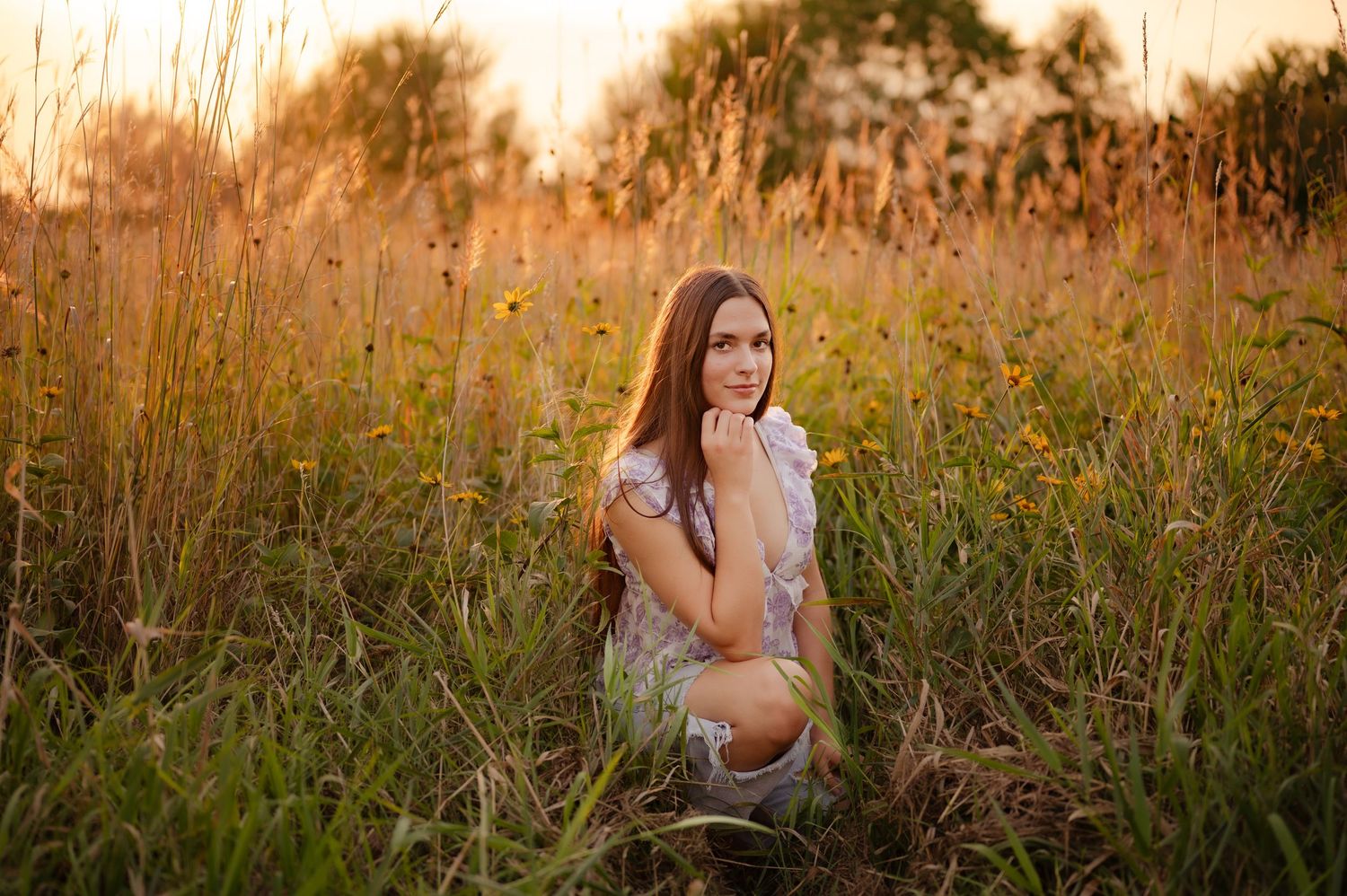 Artistic outdoor photography session in a natural meadow during sunset.