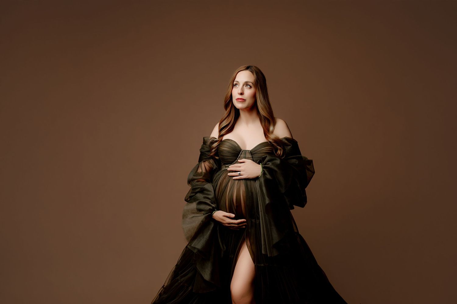 Indianapolis Maternity Studio Photoshoot pregnant mom in green tulle dress against brown background