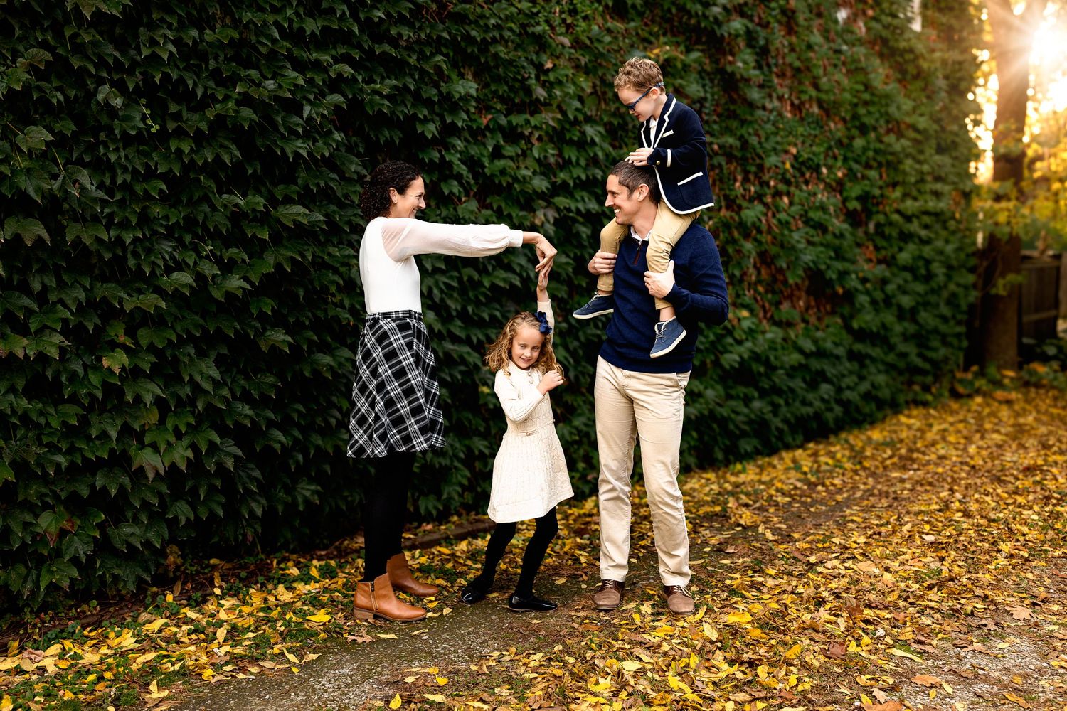 Playful family of four sunset photo shoot in urban setting Zionsville Indiana