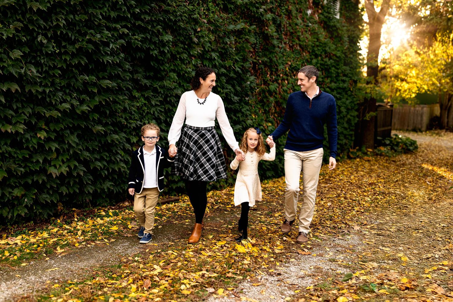 Walking family of four sunset photo shoot in urban setting Zionsville Indiana