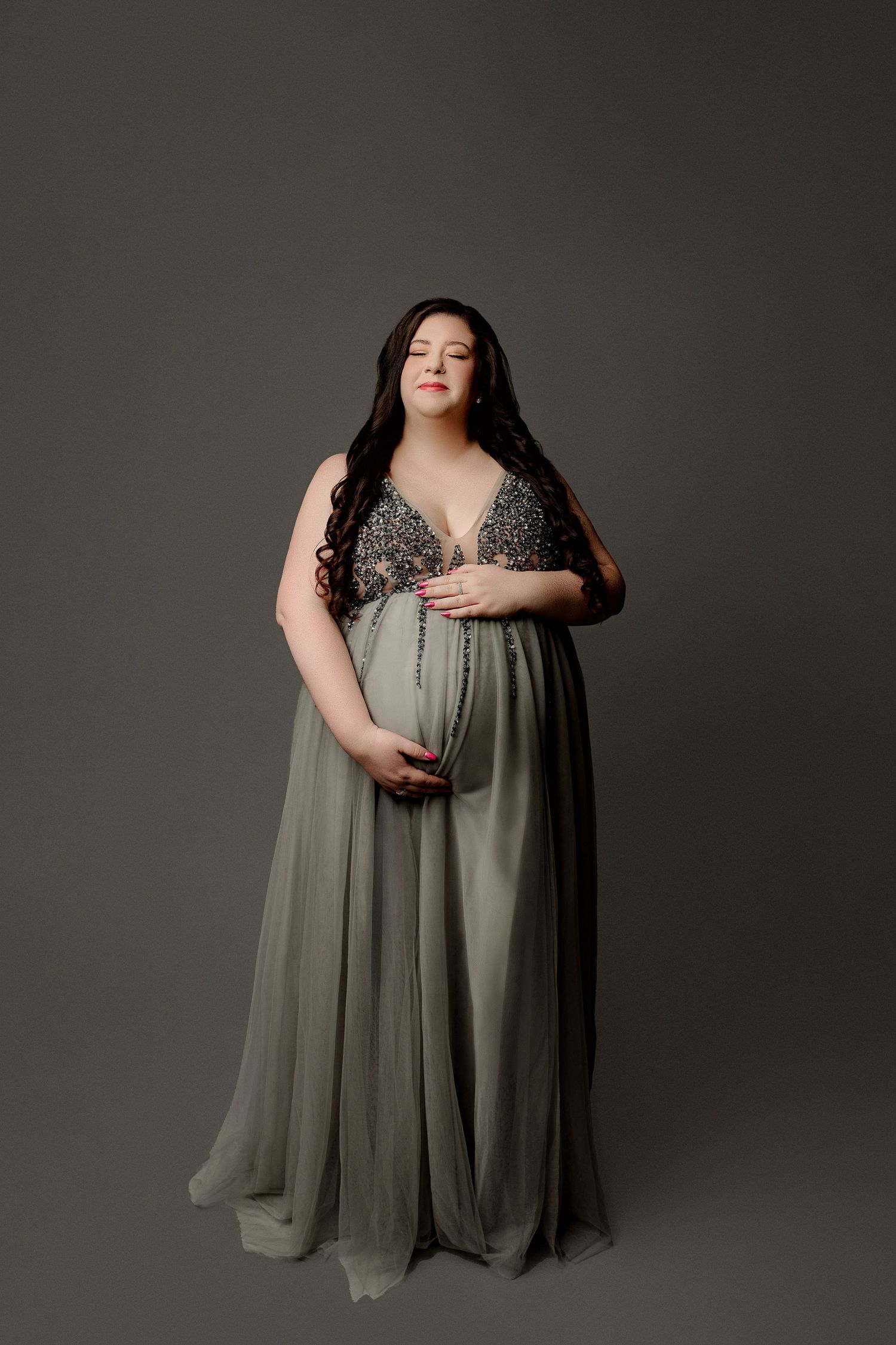 Expectant mother in elegant gray dress studio maternity portraits Indianapolis
