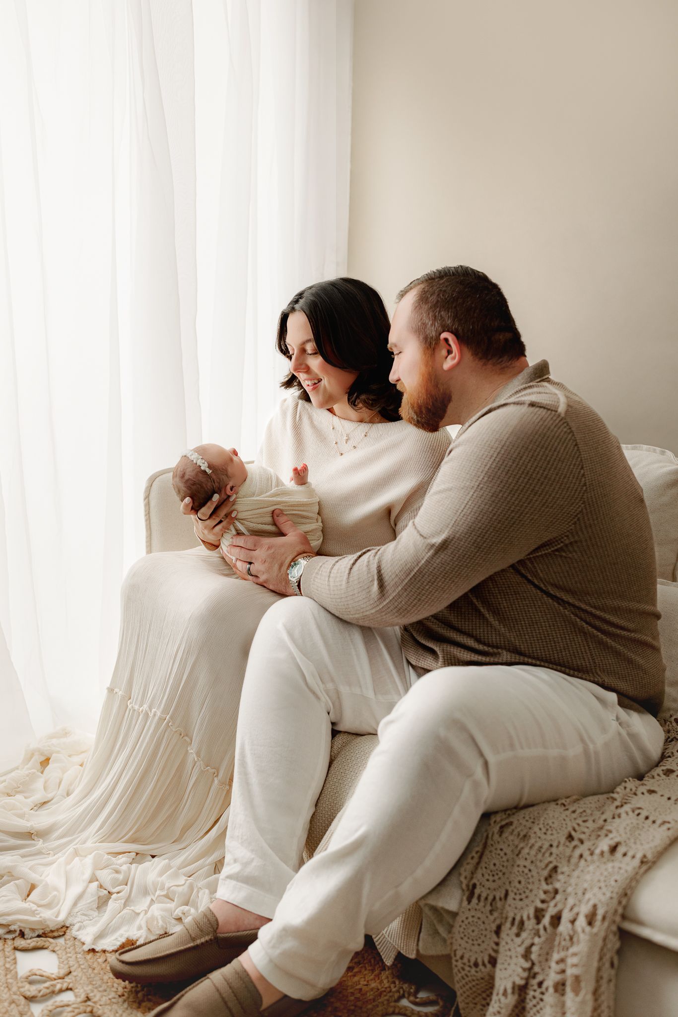 Indianapolis newborn family photo with parents holding baby in a neutral studio set up