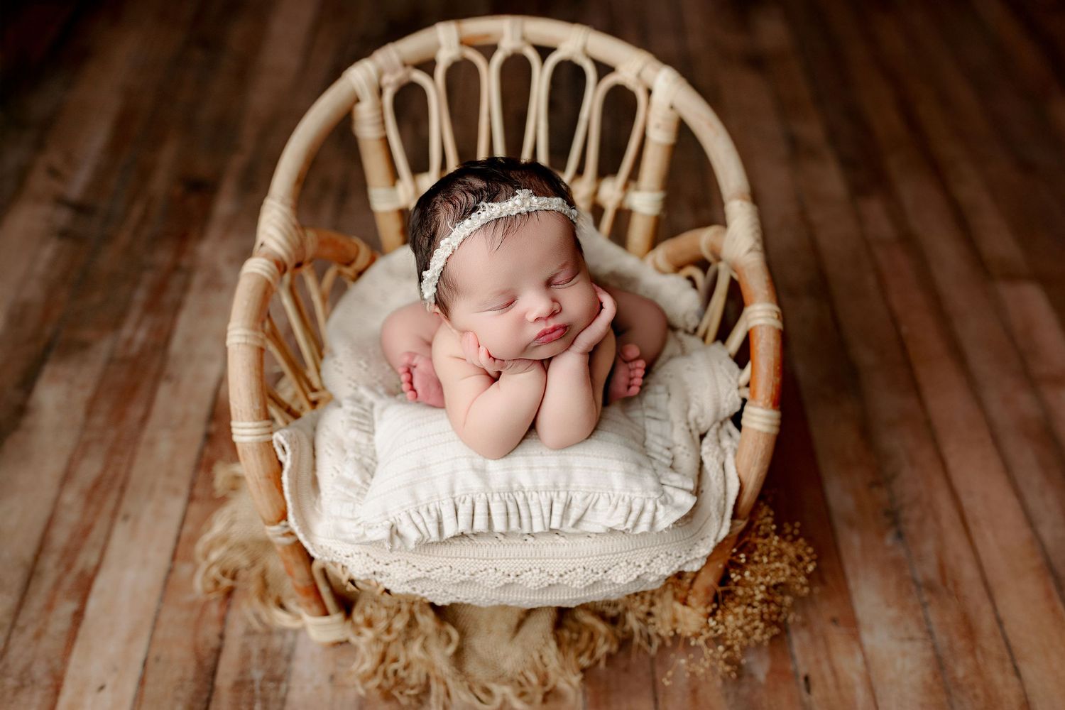 Central Indiana newborn baby girl posed on chair with neutral colors