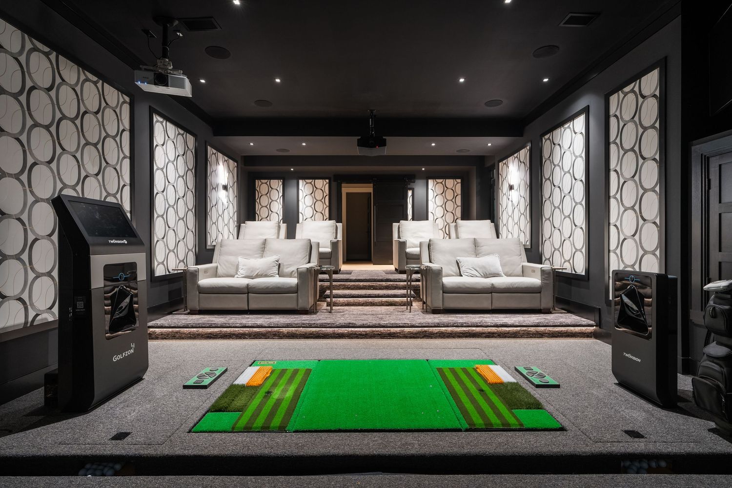 Indoor golf simulator in the basement of a luxury home.