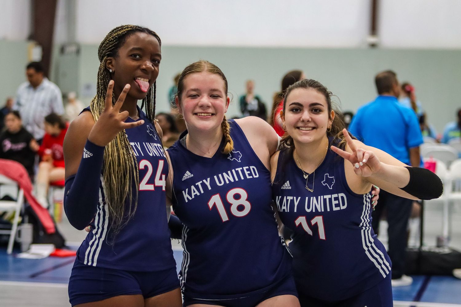 Three Katy United 16U teammates pose for a picture during club volleyball tournament in Willis, TX.