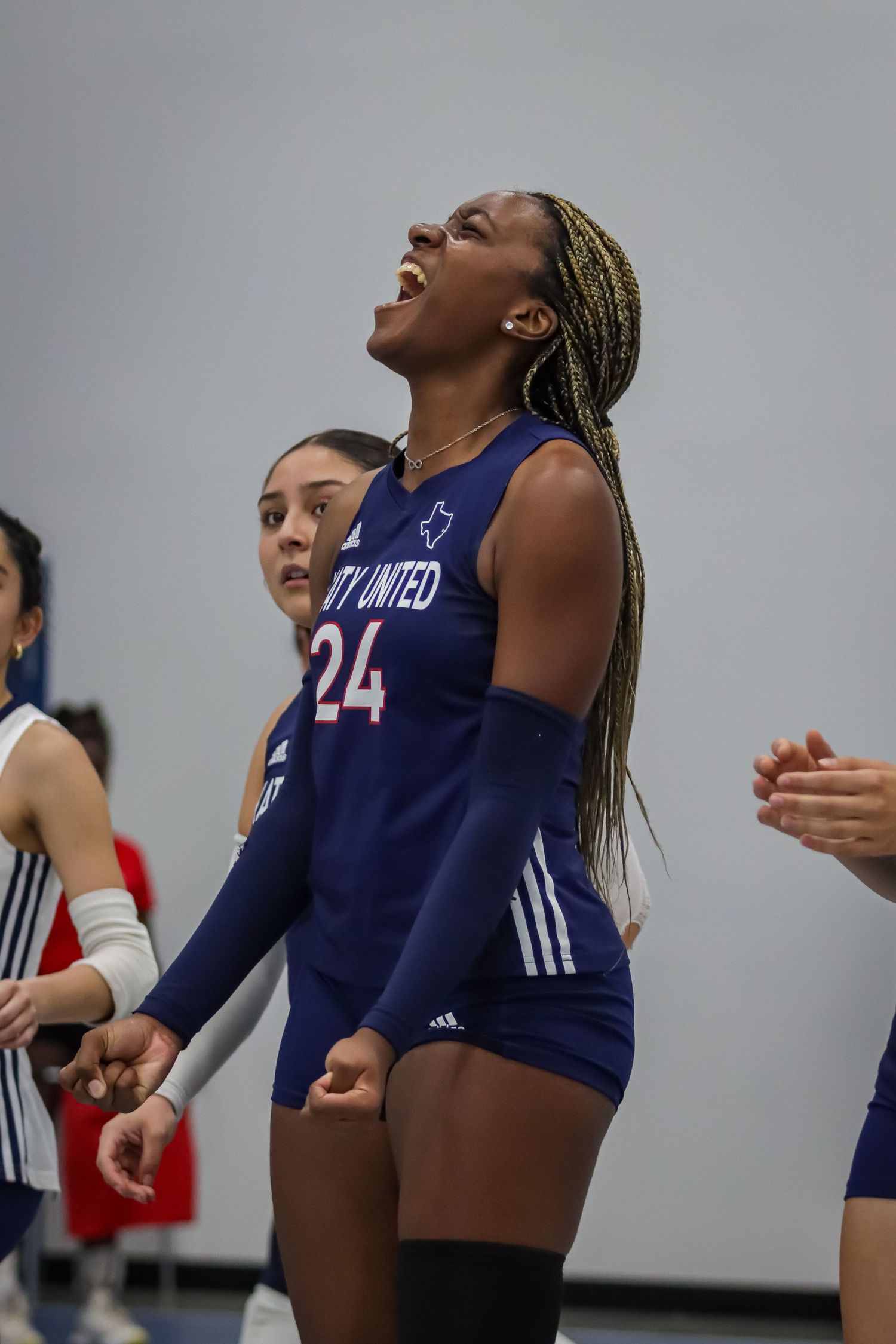 Katy United 16U volleyball player celebrating passionately during tournament in Willis, TX.