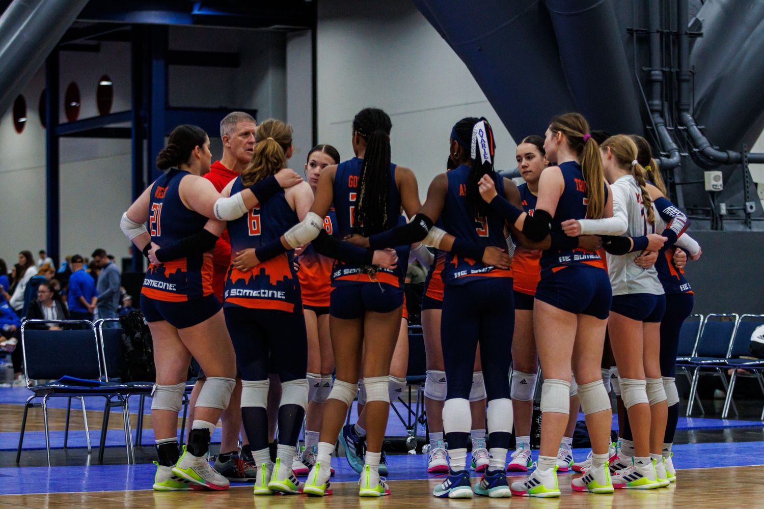 Houston Juniors 14U volleyball team huddling during a timeout in a Houston tournament.