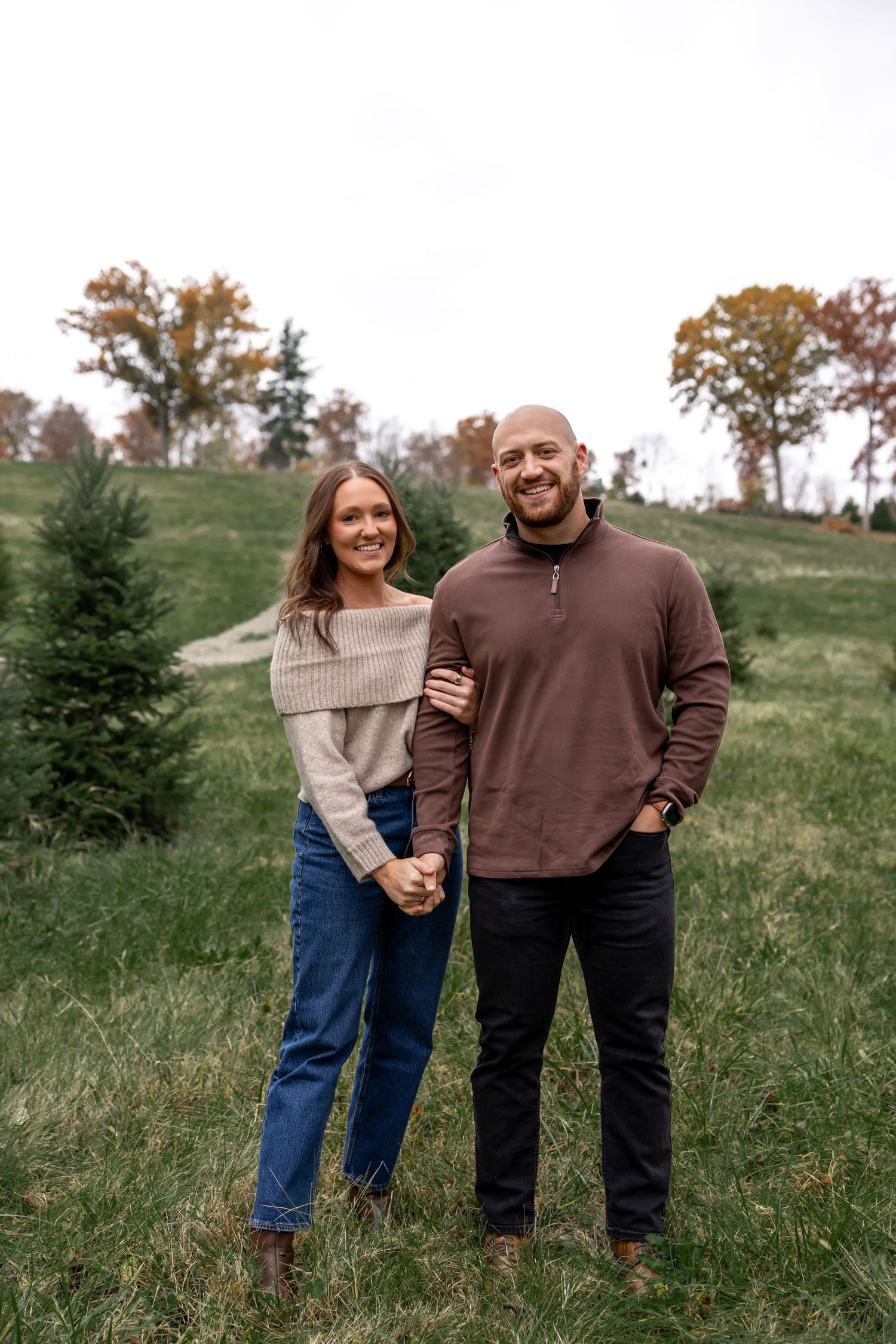 A casual outdoor photo sequence of a couple in sweaters on a grassy hillside.