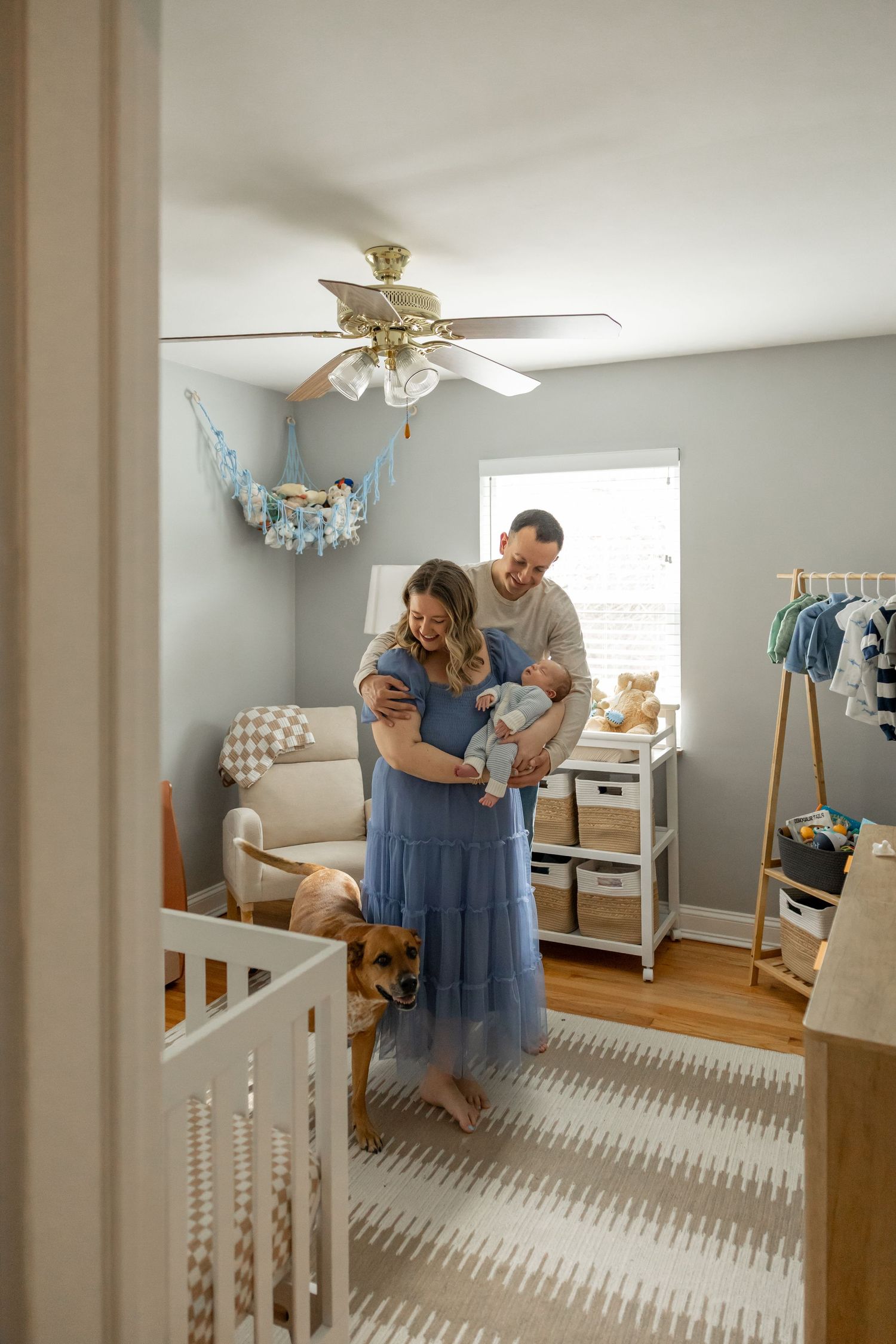 Nursery room reveal showing parents looking at their baby's newly decorated space.