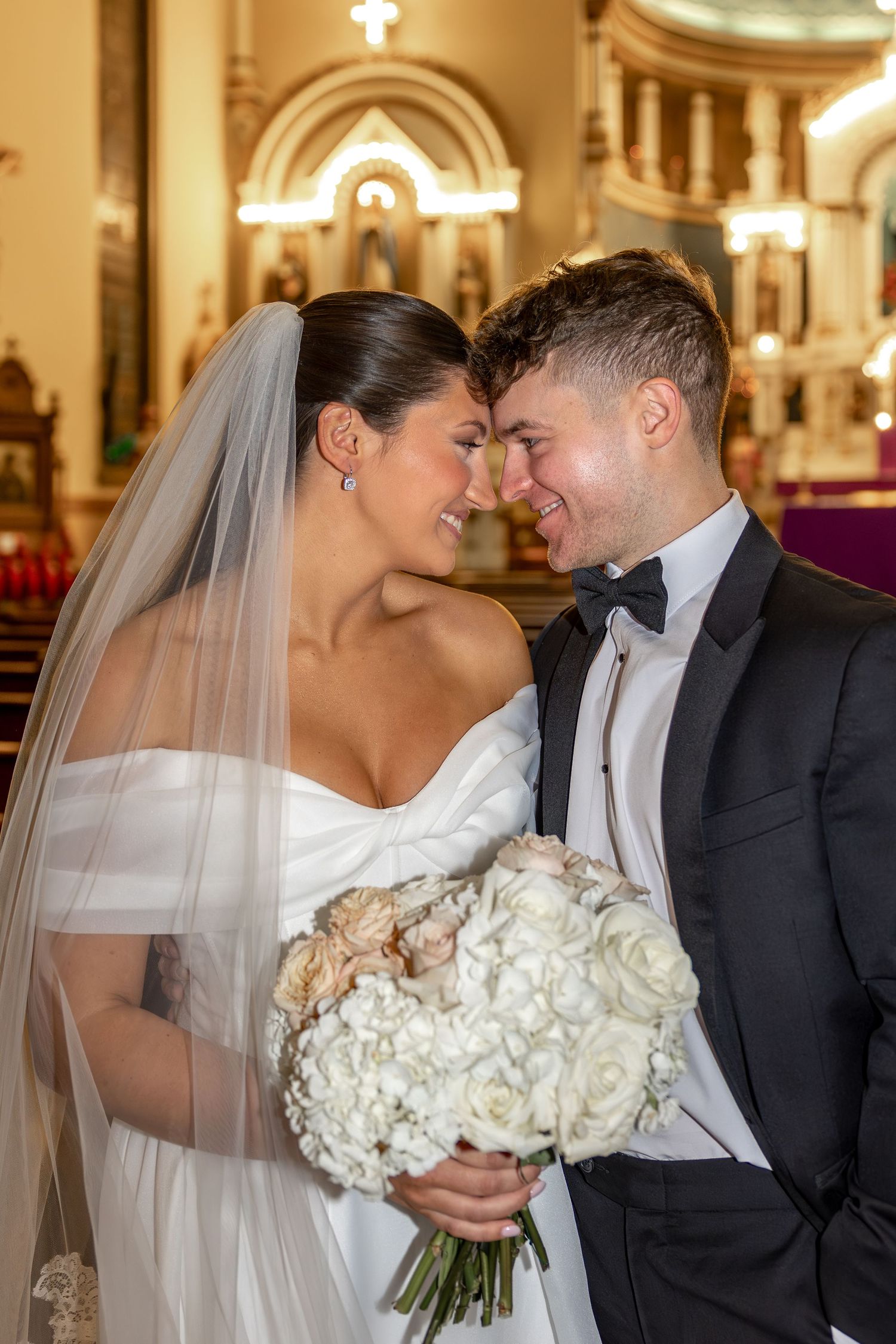 Romantic wedding photos showing tender moments between newlyweds in an ornate church setting.