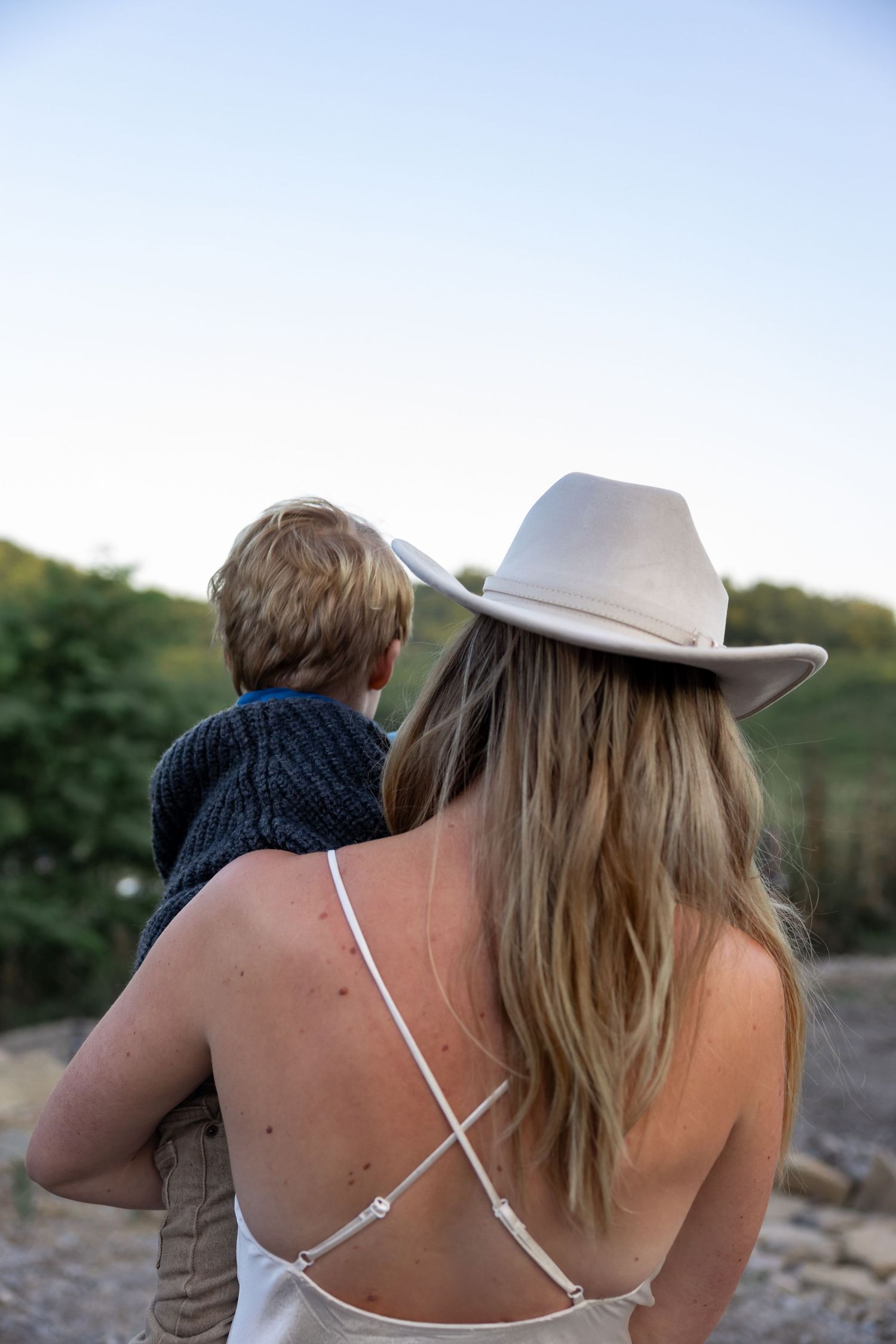 Back view of two people watching sunset in rural setting.