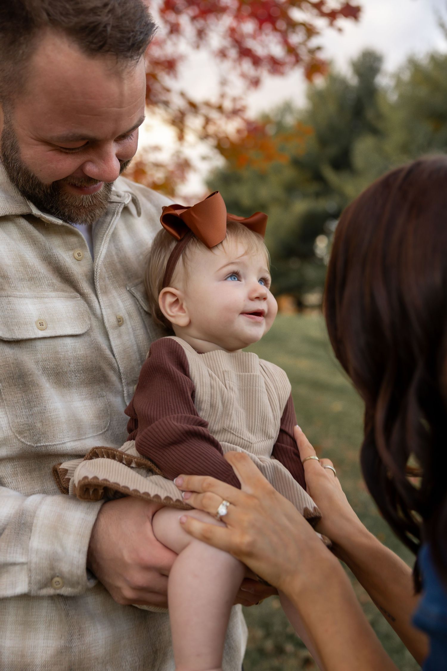 Tender family moment captured outdoors during autumn.