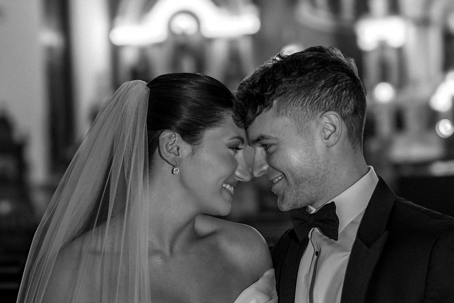 Intimate black and white portraits of newlyweds sharing romantic moments.
