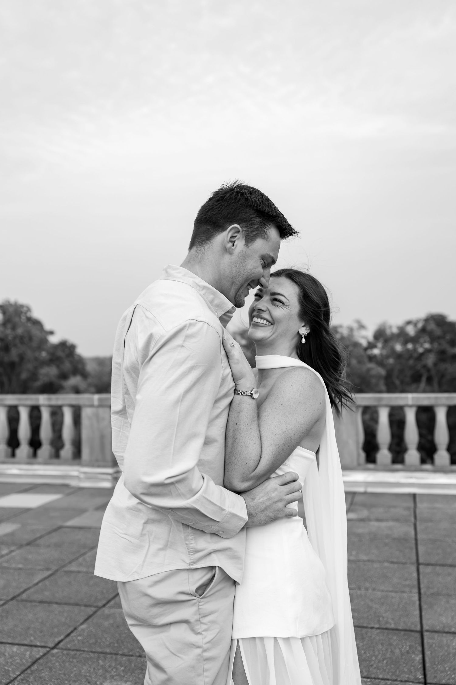 Black and white photo of a joyful moment shared on an outdoor terrace.