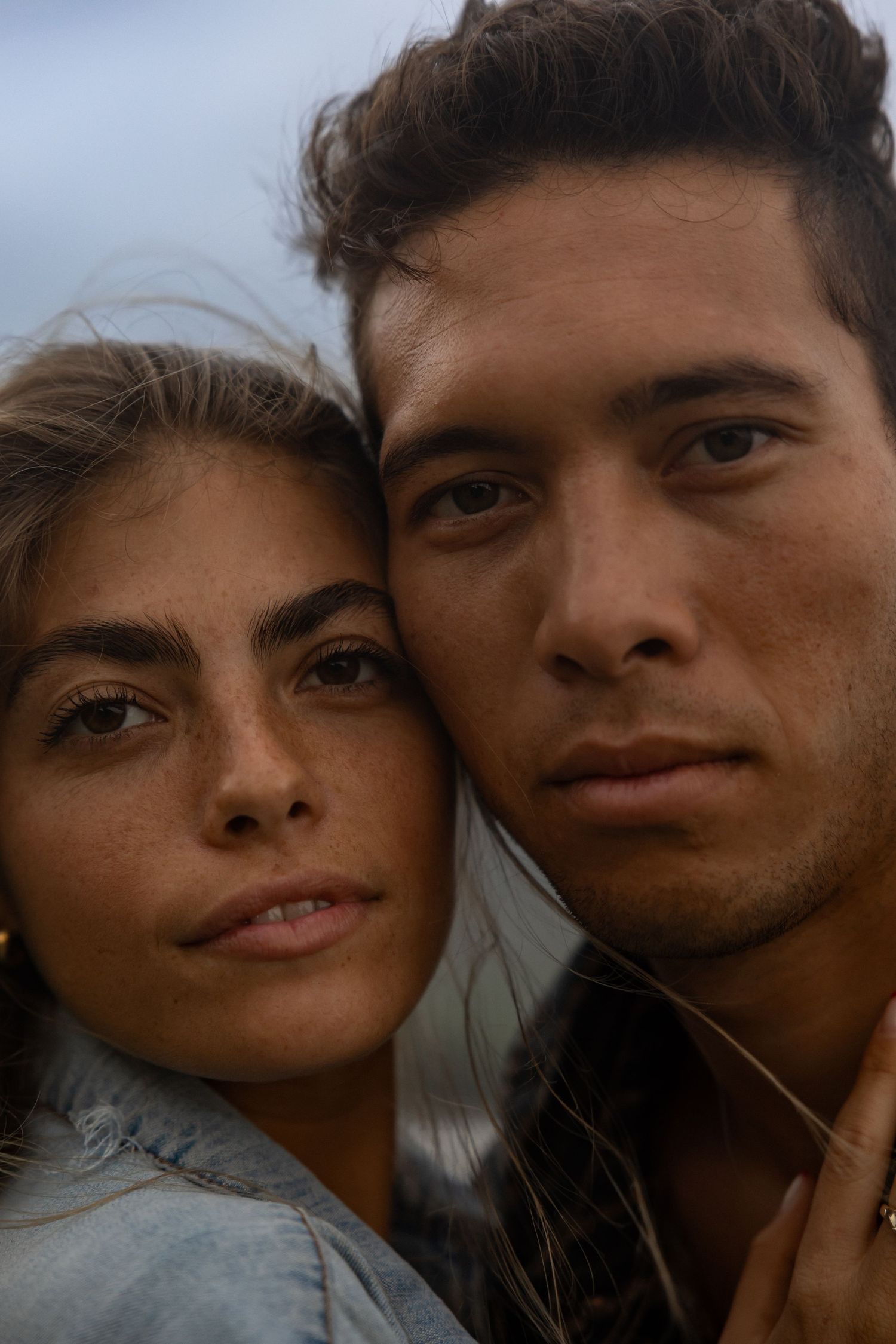 Close up romantic couple portraits showing tender moments against a blurred background.