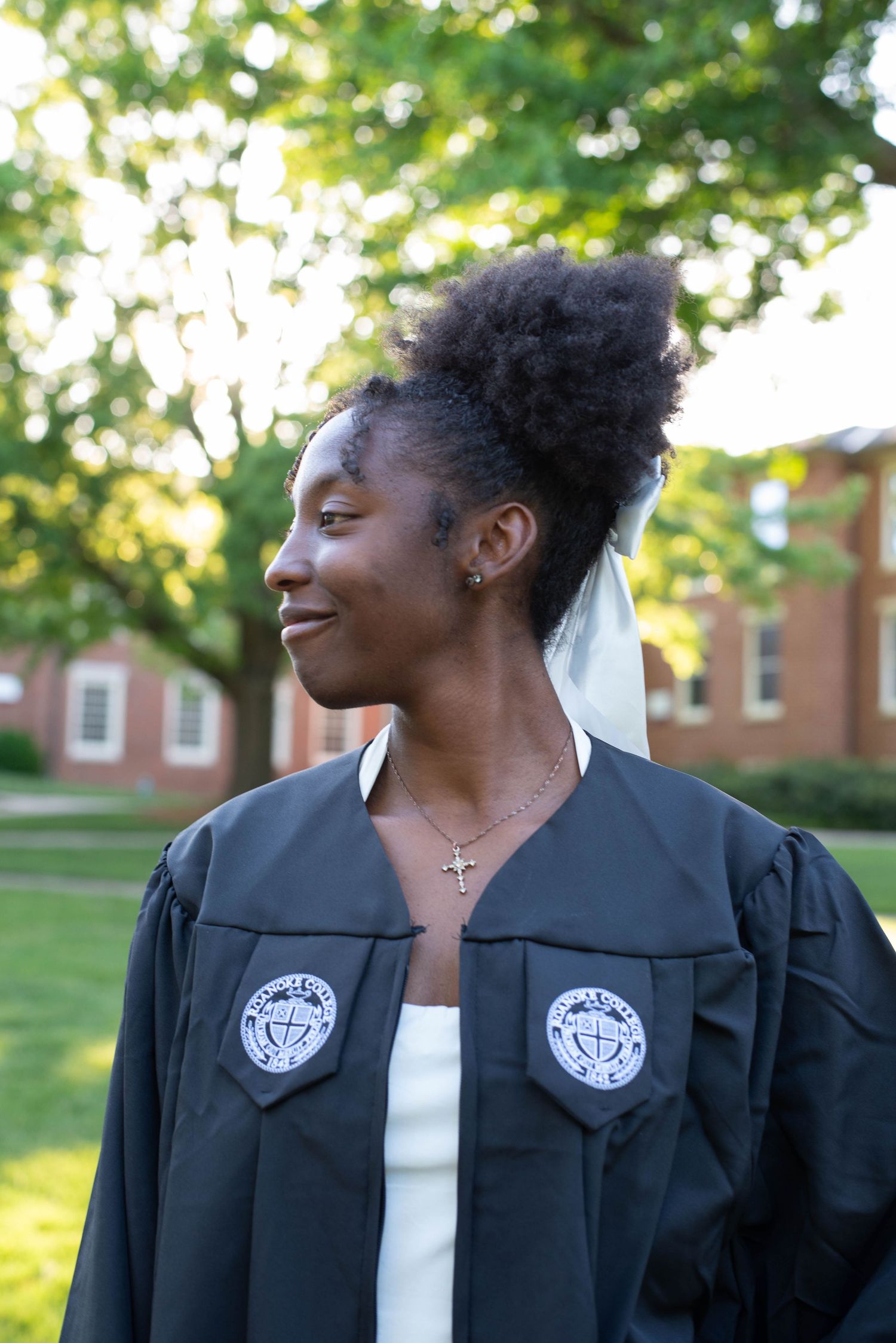 Senior graduation photos of a girl in her robe on campus