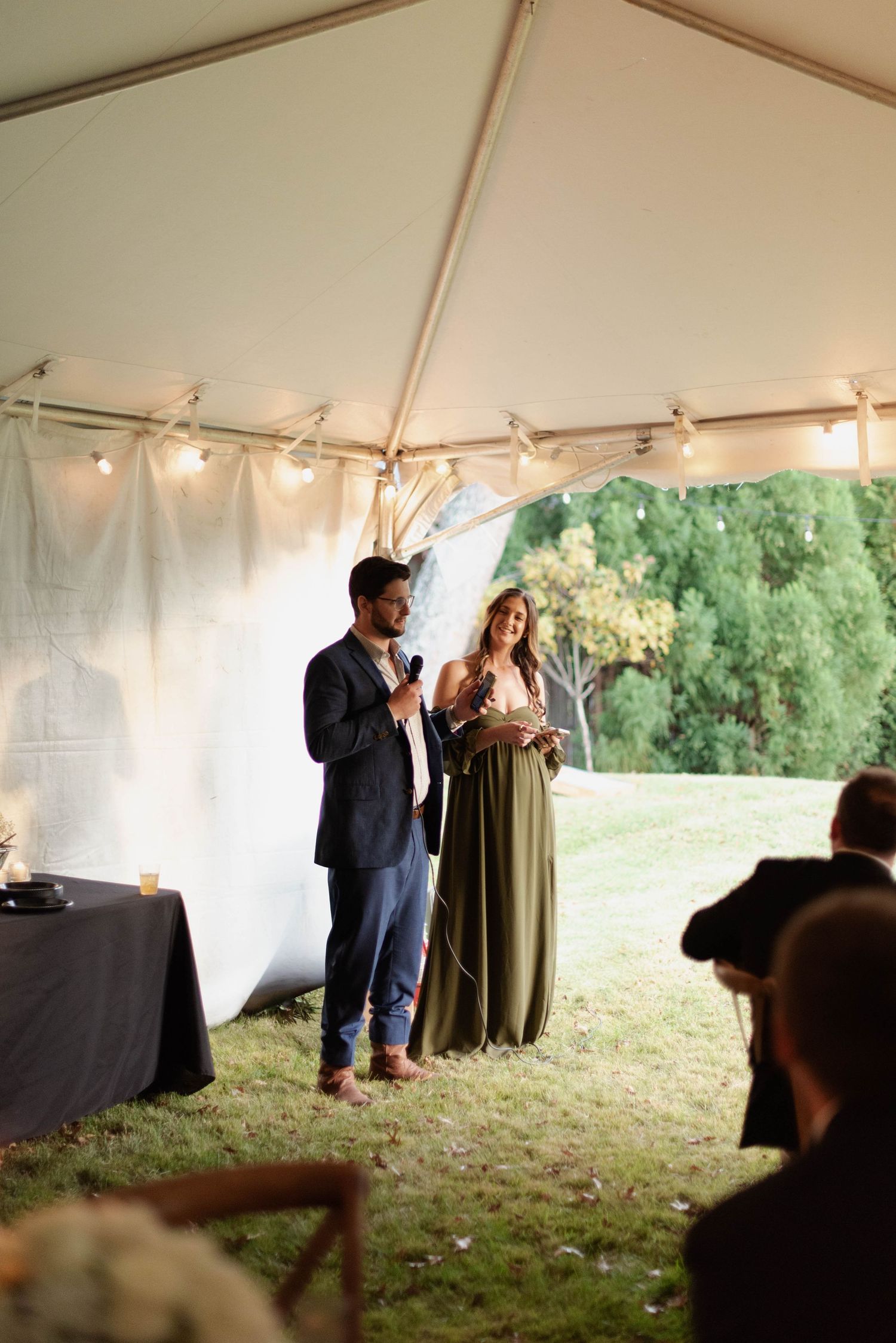 Best man and maid of honor giving speech at wedding reception