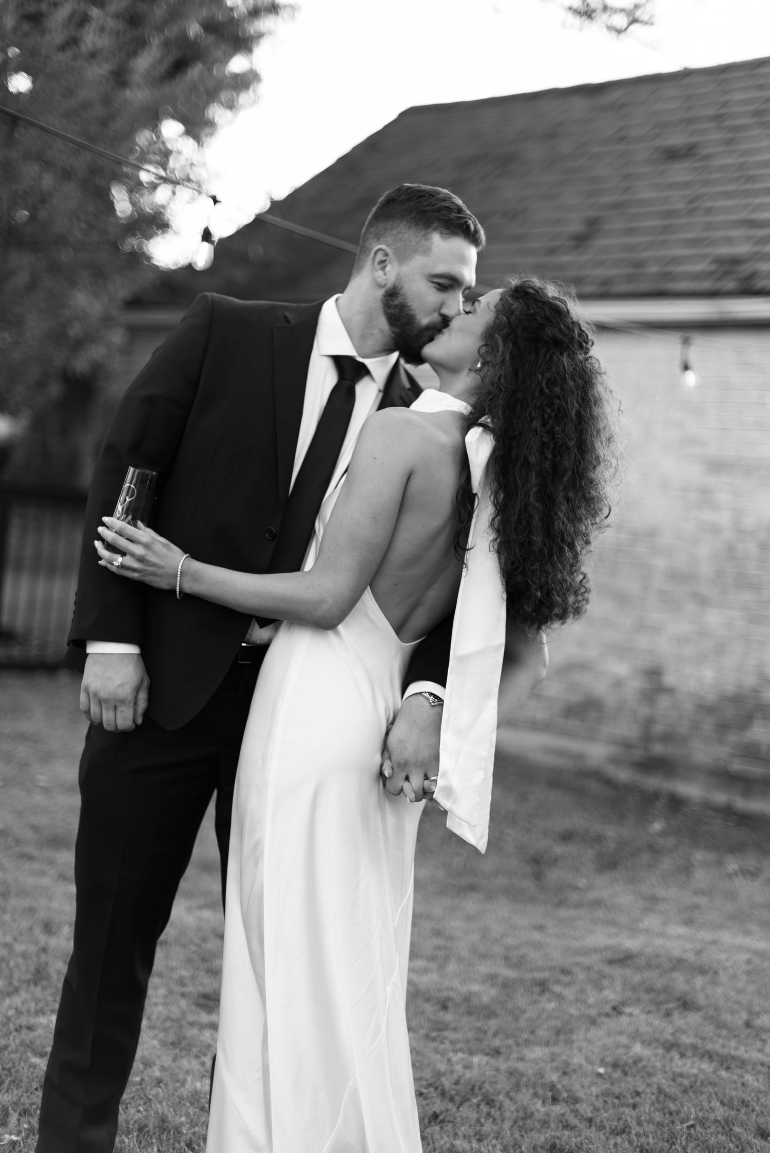 Bride and groom after wedding during reception kissing and celebrating