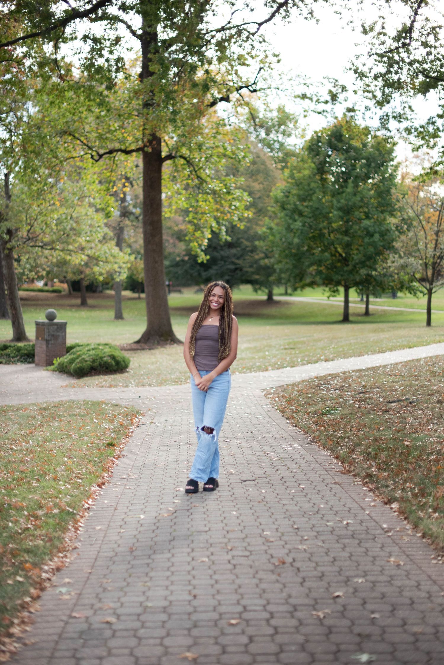 Portrait session of a girl surrounded by trees and walkways