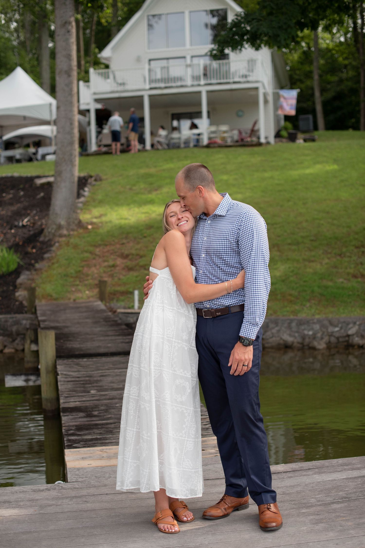 bride and groom hugging with venue in background