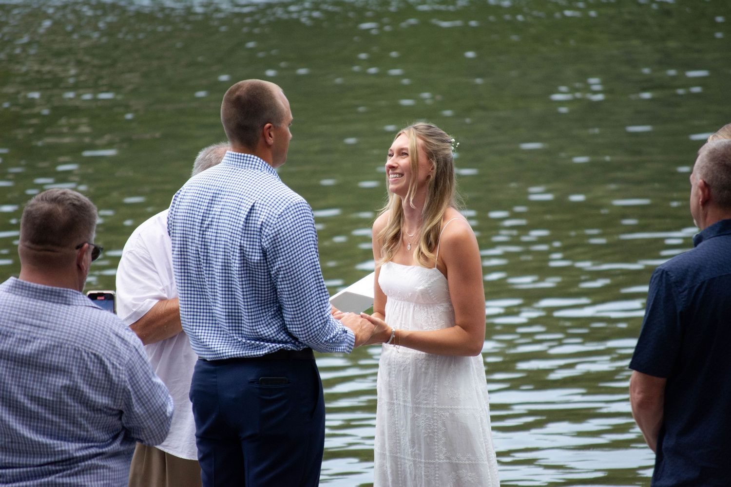 Bride smiling at her groom during wedding ceremony
