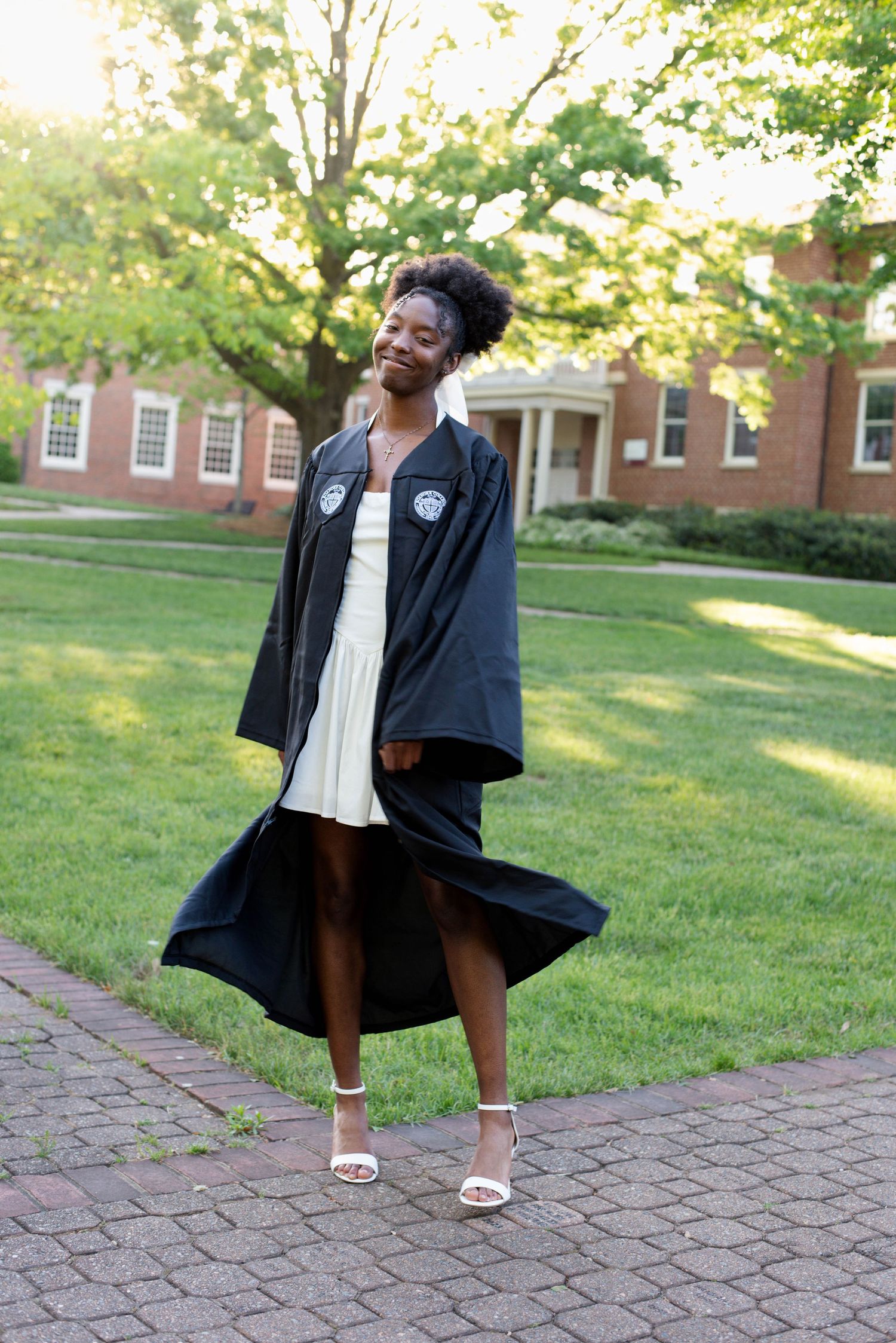 Senior graduation photos of a girl in her robe on campus