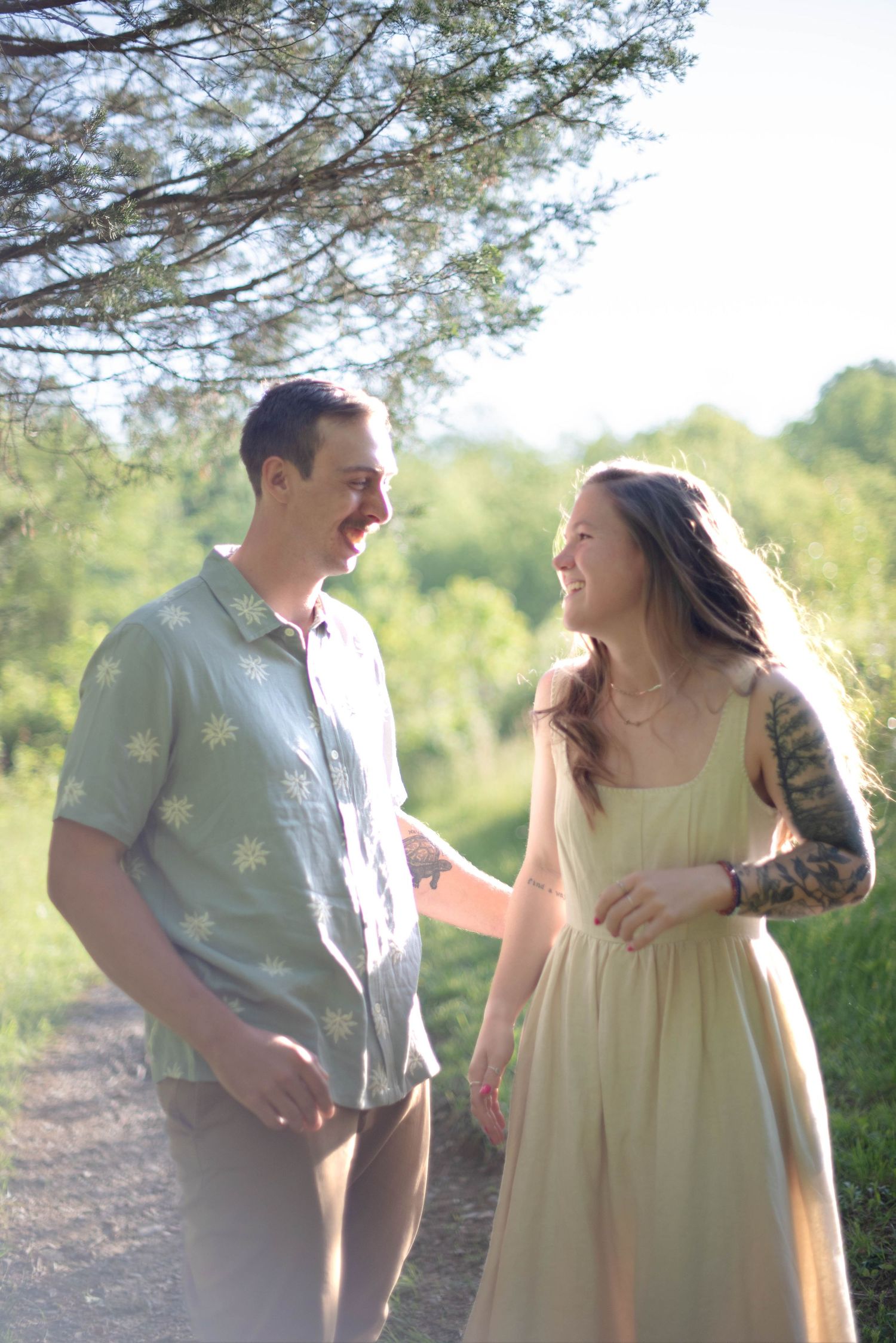 Couple laughing on a trail in the woods
