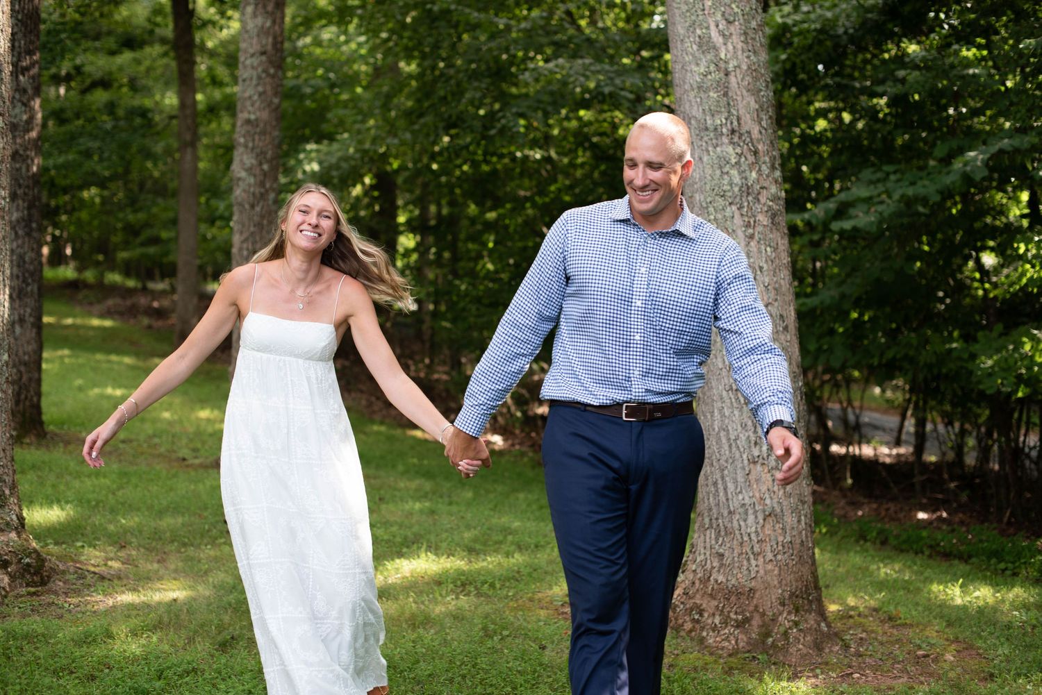 bride and groom walking playfully while holding hands