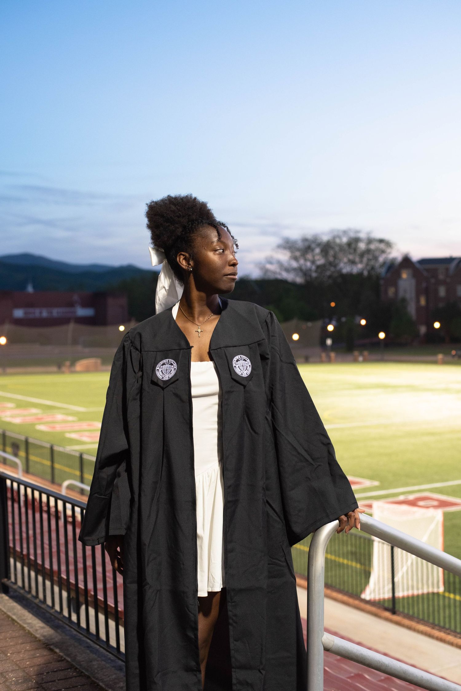 Graduation senior photos of a girl looking into the distance on campus.