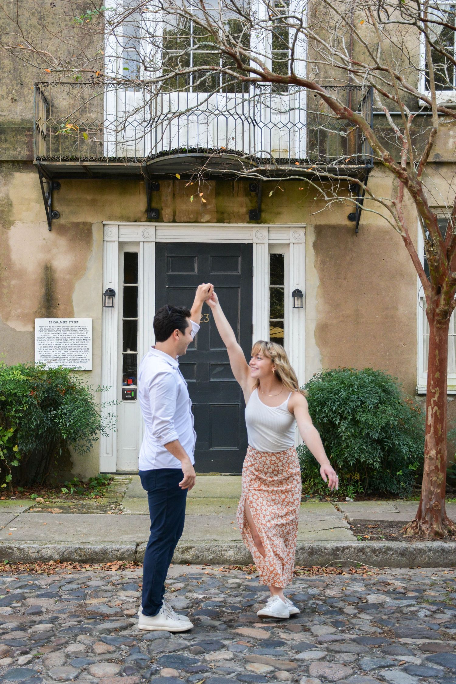 Engagement photo session. Couple spinning in Charleston, SC