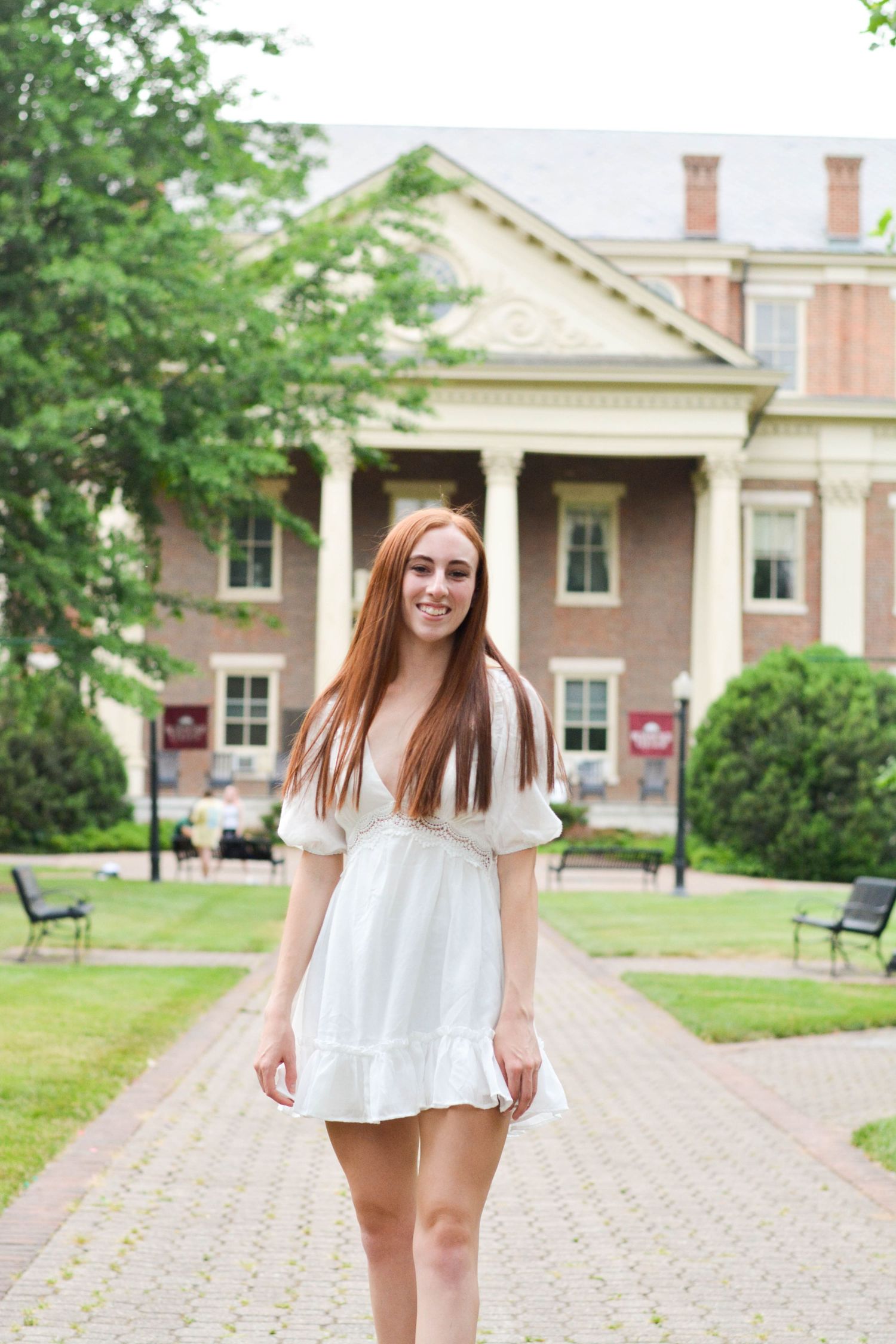 Senior graduation in front of administration building on campus, Roanoke College during senior portrait session