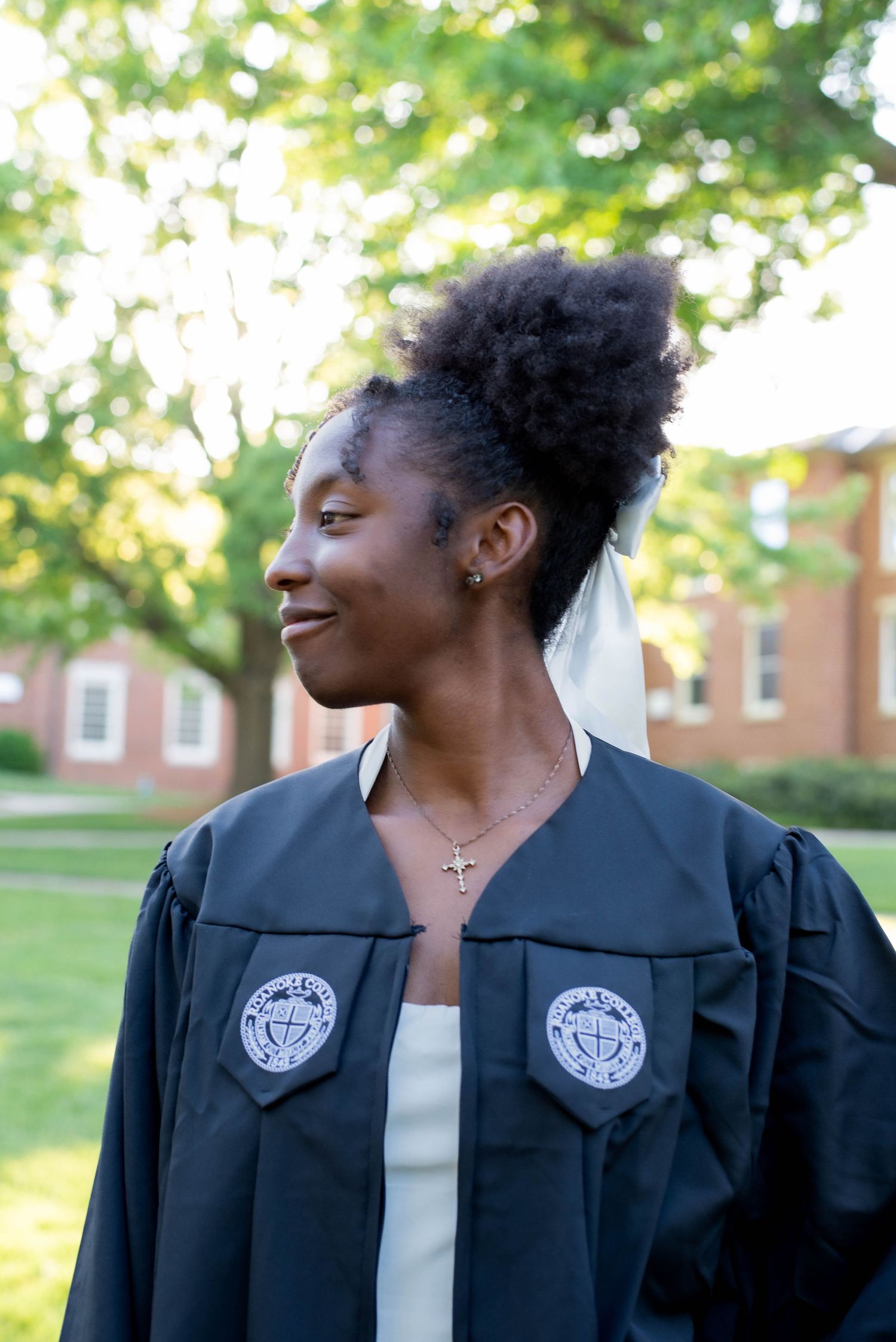 Senior graduating in robes on campus