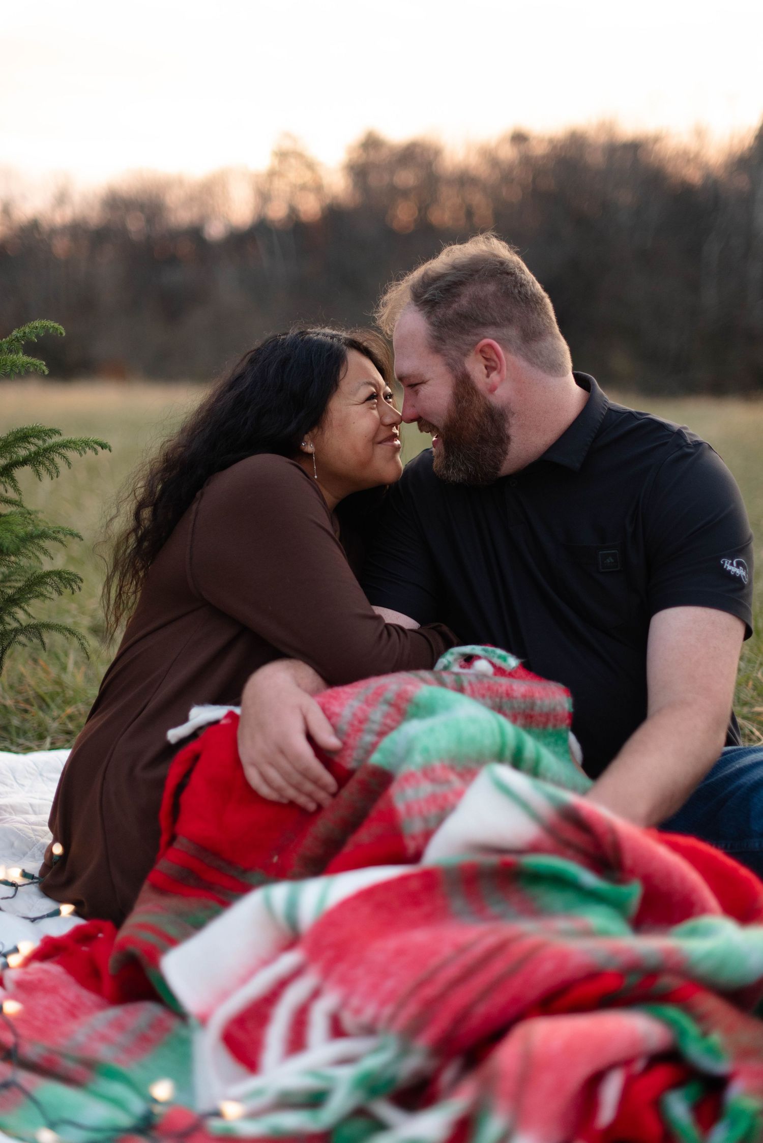 Parents sitting in a field holding an ultrasound during lifestyle session