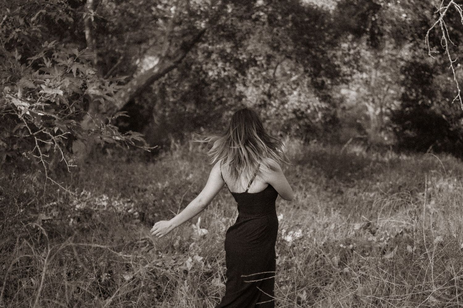 Kelsey Nevell spins facing backward from the camera in a black and white photo.
